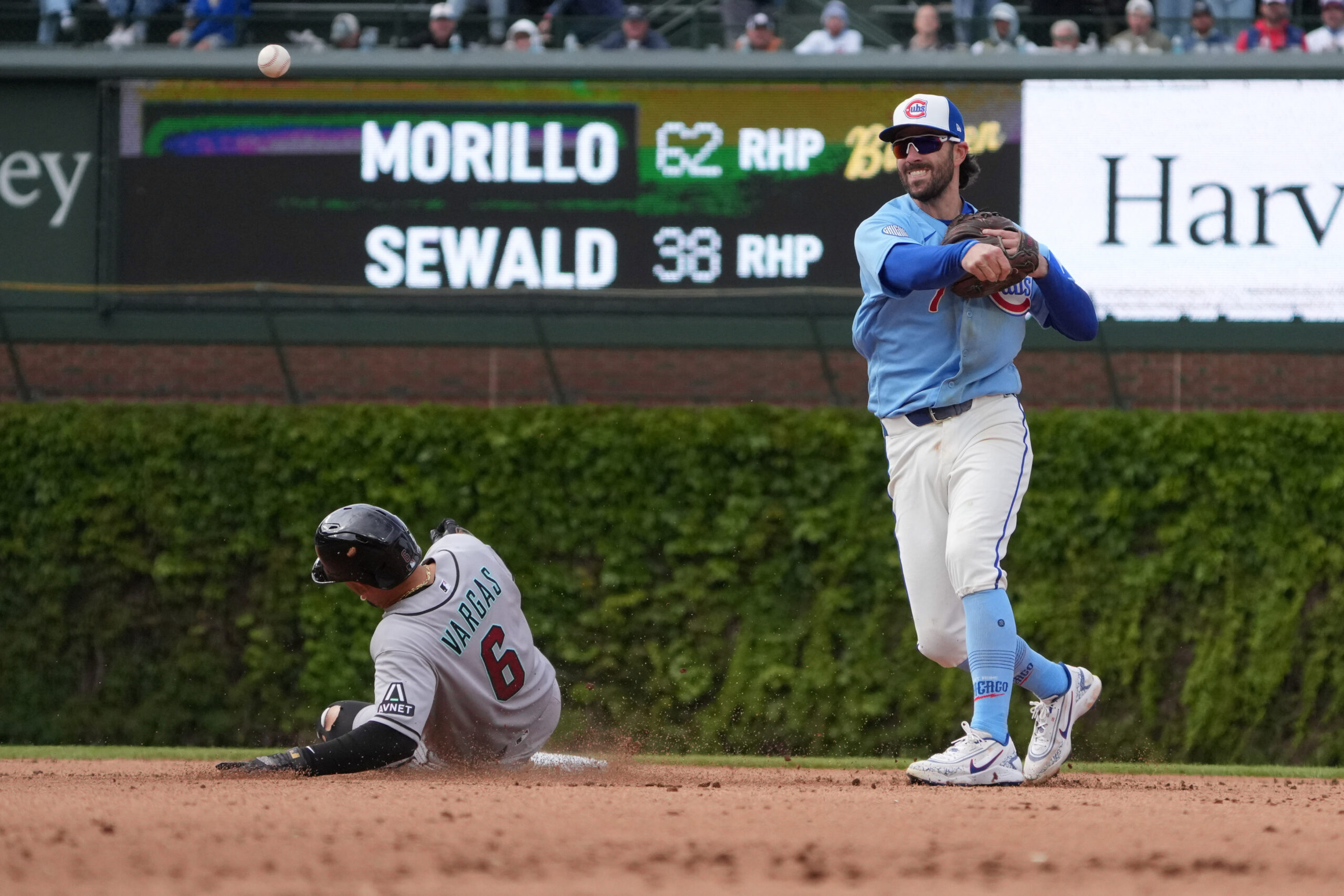 May 1, 2026; Chicago, Illinois, USA; Chicago Cubs shortstop Dansby Swanson (7) forces out Arizona Diamondbacks second baseman Ildemaro Vargas (6)at second base during the ninth inning at Wrigley Field. Mandatory Credit: David Banks-Imagn Images