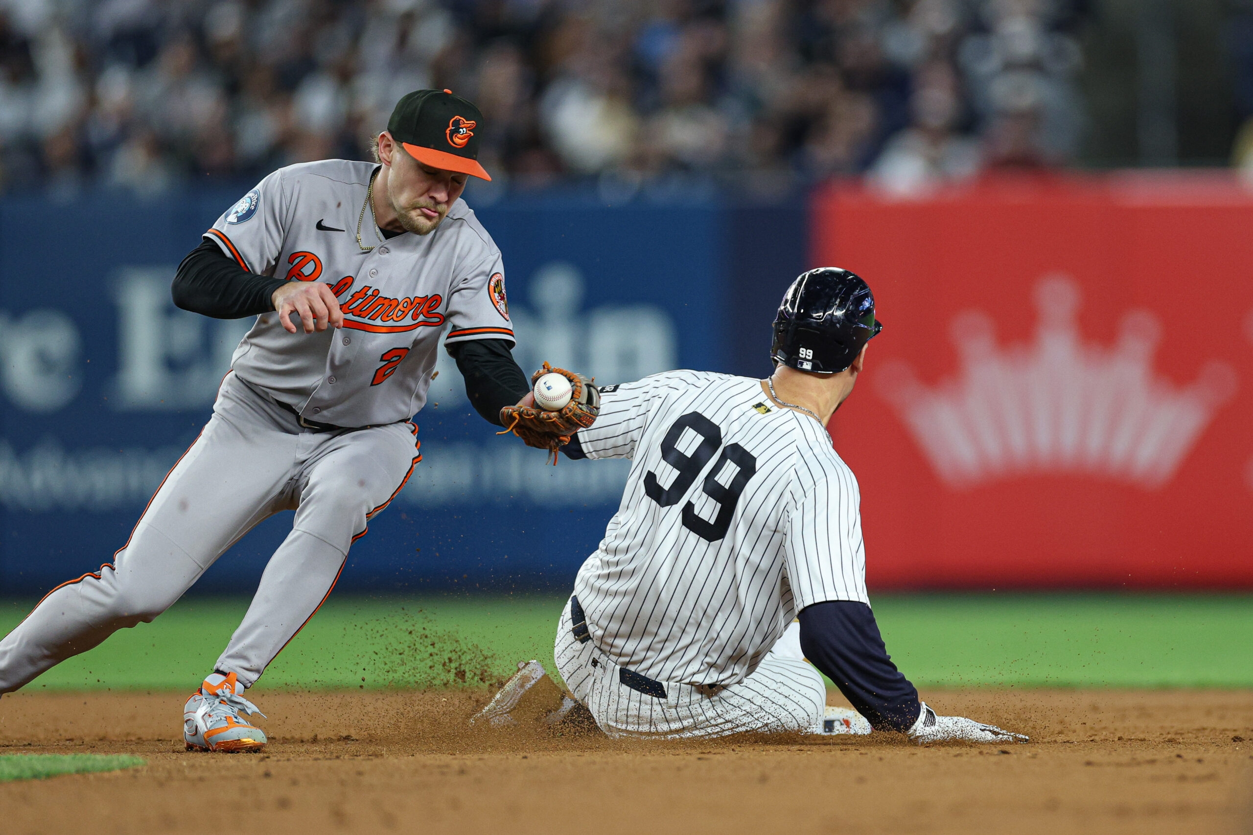 May 1, 2026; Bronx, New York, USA; New York Yankees right fielder Aaron Judge (99) slides in to second base as Baltimore Orioles shortstop Gunnar Henderson (2) can not secure the throw during the seventh inning at Yankee Stadium. Mandatory Credit: Vincent Carchietta-Imagn Images