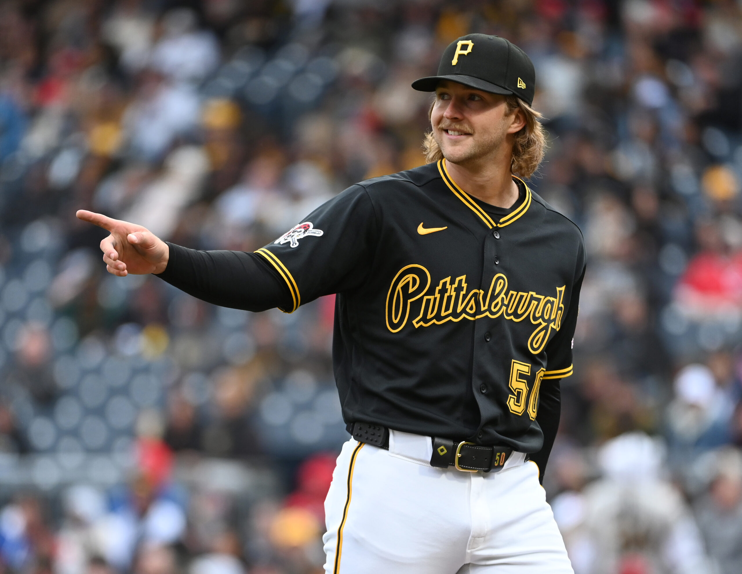 May 2, 2026; Pittsburgh, Pennsylvania, USA;  Pittsburgh Pirates starting pitcher Carmen Mlodzinski gestures to center fielder Oneil Cruz after making a catch against the Cincinnati Reds to end  the fourth inning at PNC Park. Mandatory Credit: Philip G. Pavely-Imagn Images