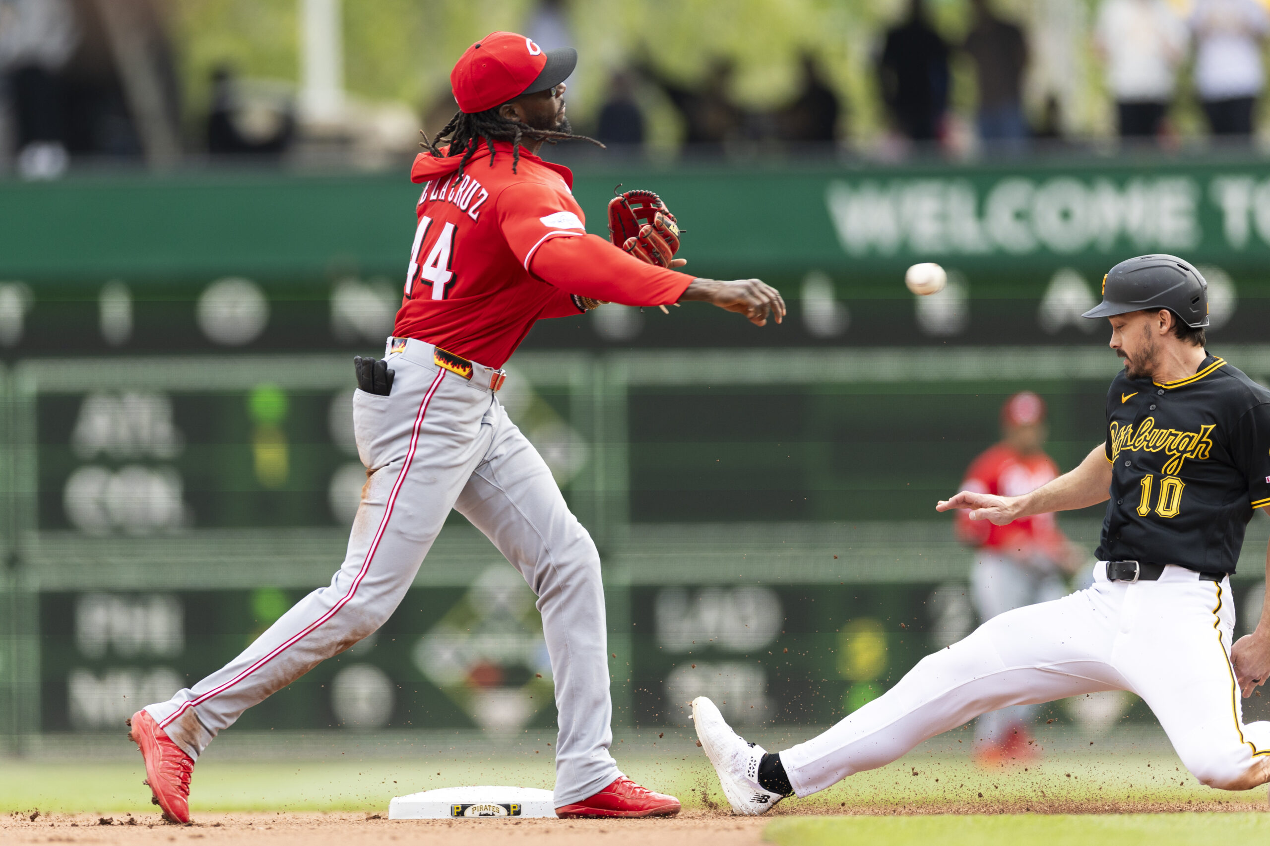 May 3, 2026; Pittsburgh, Pennsylvania, USA;  Cincinnati Reds shortstop Elly De La Cruz (44) makes the throw to complete a double play as Pittsburgh Pirates left fielder Bryan Reynolds (10) slides into second base during the seventh inning at PNC Park. Mandatory Credit: Scott Galvin-Imagn Images