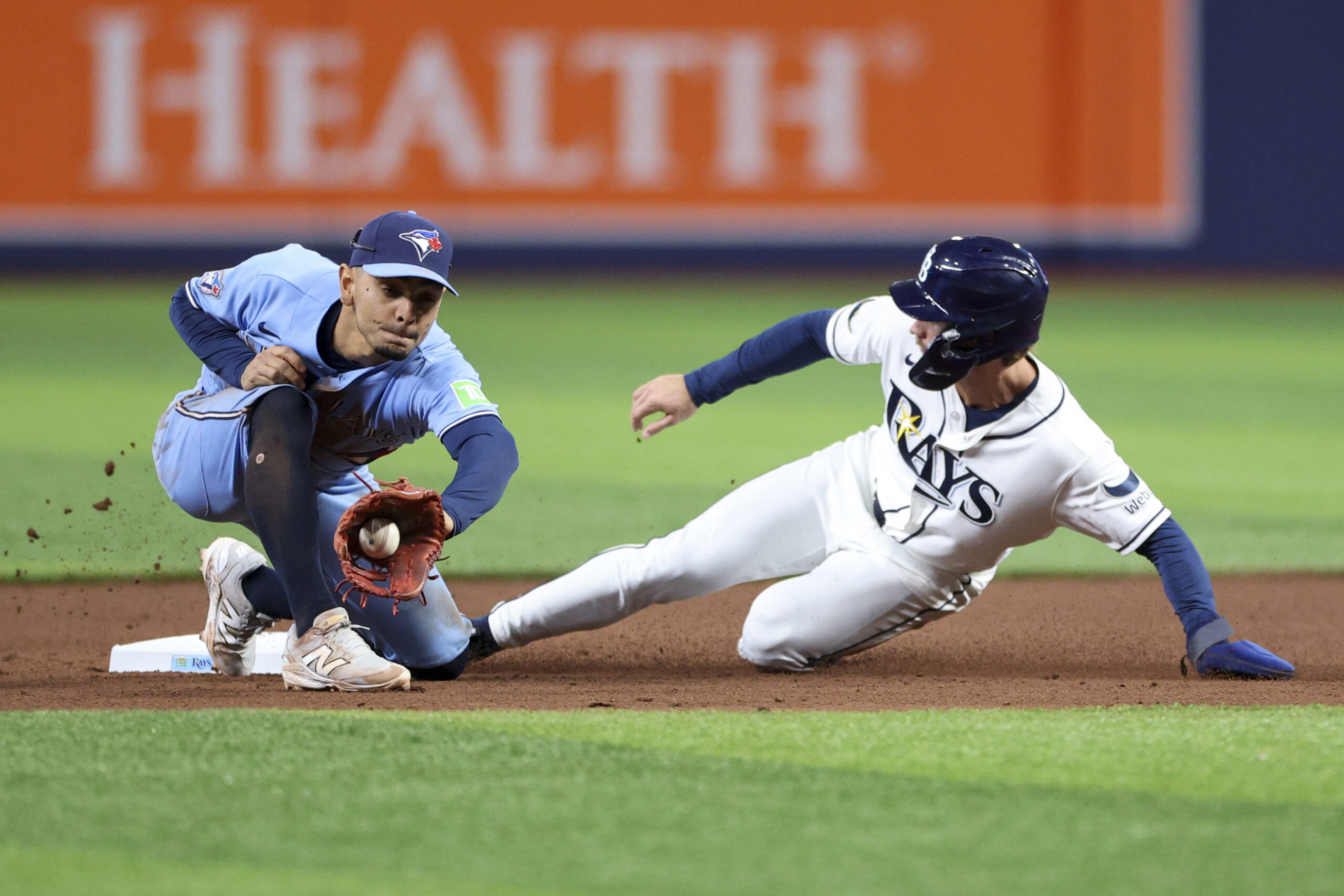 May 5, 2026; St. Petersburg, Florida, USA; Tampa Bay Rays right fielder Jonny DeLuca (21) steals second base from Toronto Blue Jays shortstop Andres Gimenez (0) in the seventh inning at Tropicana Field. Mandatory Credit: Nathan Ray Seebeck-Imagn Images