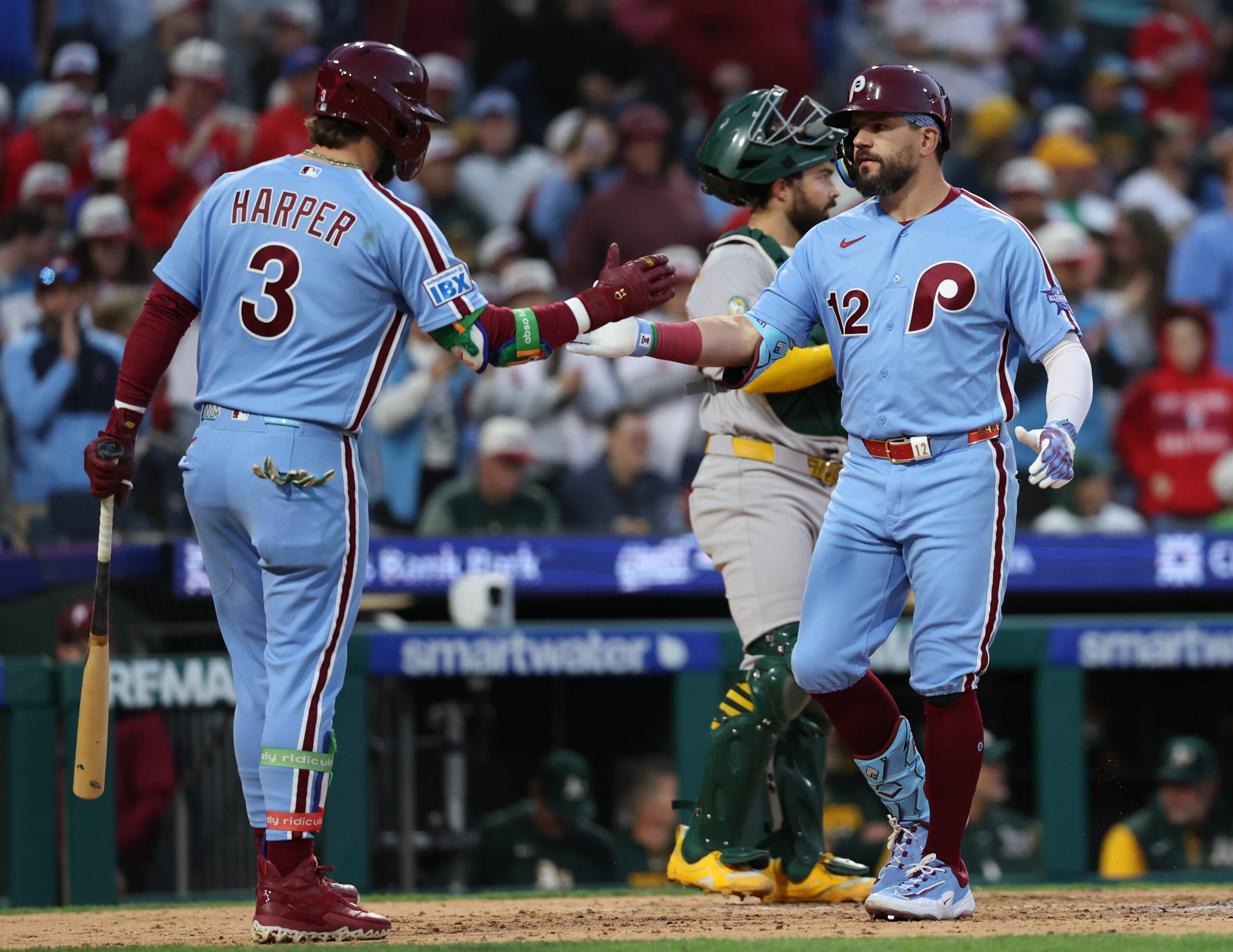 May 7, 2026; Philadelphia, Pennsylvania, USA; Philadelphia Phillies left fielder Kyle Schwarber (12) is congratulated by first baseman Bryce Harper (3) after hitting a home run against the Athletics at Citizens Bank Park. Mandatory Credit: Bill Streicher-Imagn Images