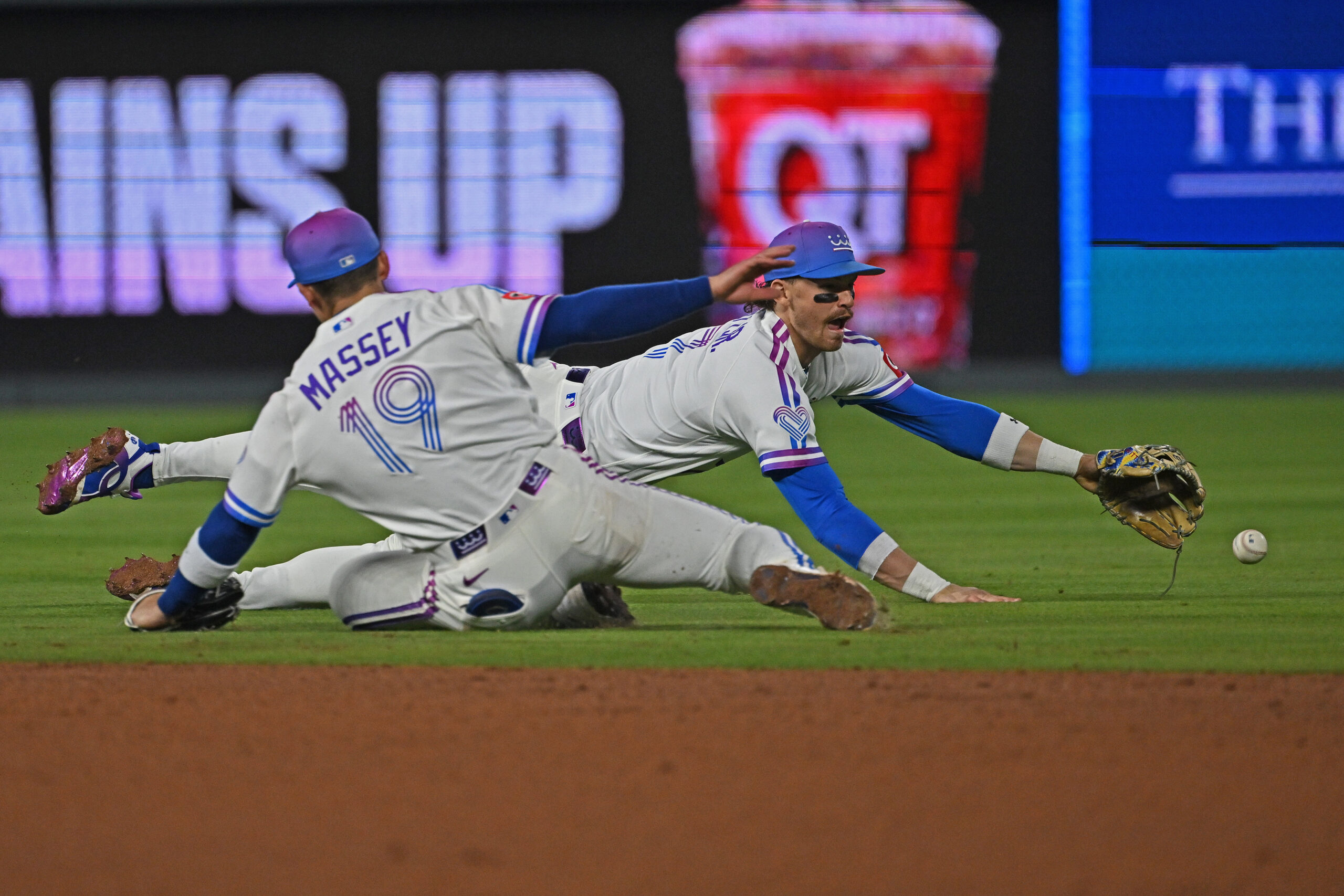 May 8, 2026; Kansas City, Missouri, USA;  Kansas City Royals shortstop Bobby Witt Jr. (7) dives for the ball past second baseman Michael Massey (19) in the eighth inning against the Detroit Tigers at Kauffman Stadium. Mandatory Credit: Peter Aiken-Imagn Images