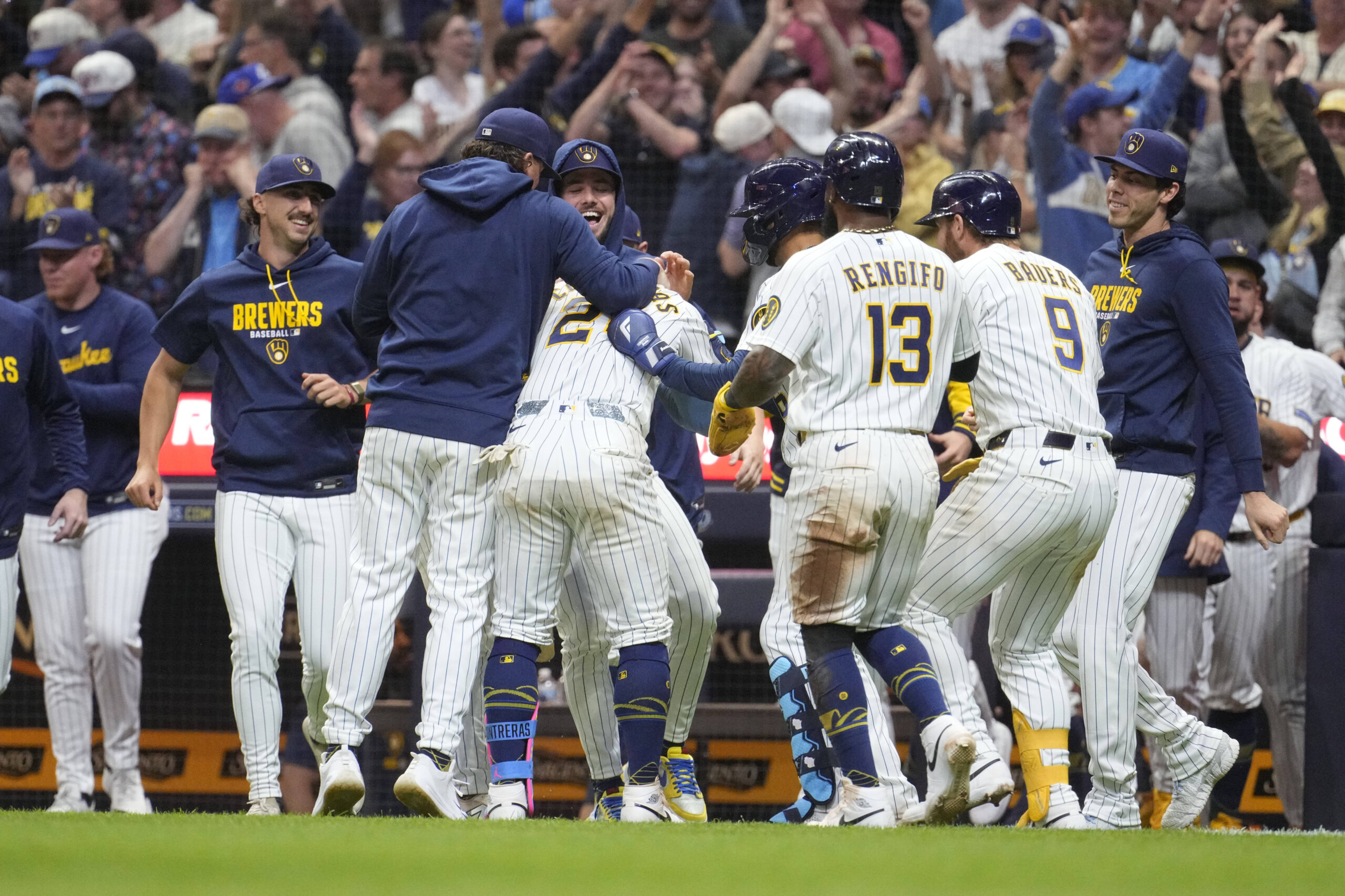 May 9, 2026; Milwaukee, Wisconsin, USA; Milwaukee Brewers pitcher Trevor Megill (29) and the rest of the Milwaukee Brewers bench swarm catcher William Contreras (24) driving in the winning run against the New York Yankees win the tenth inning at American Family Field. Mandatory Credit: Michael McLoone-Imagn Images