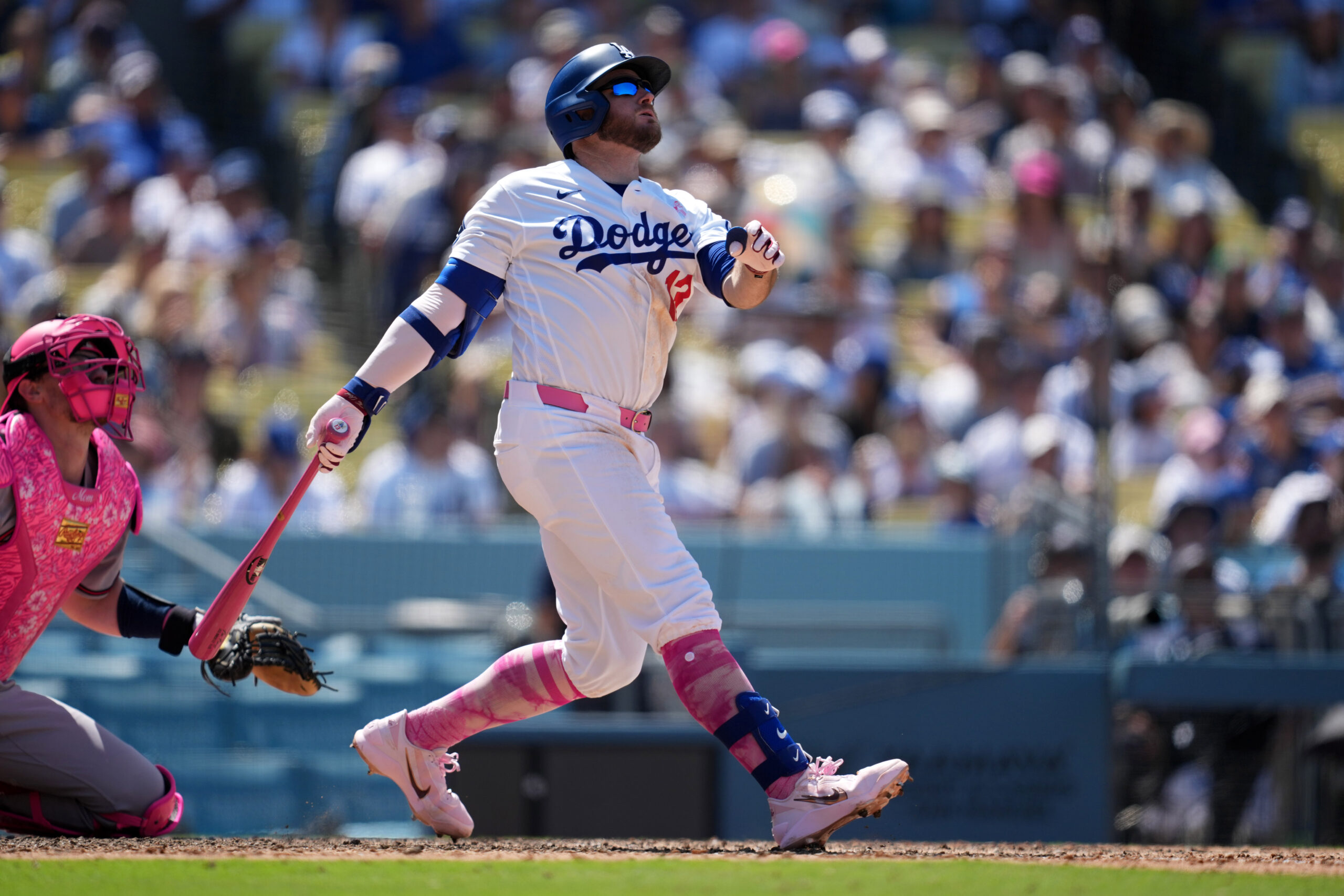 May 10, 2026; Los Angeles, California, USA; Los Angeles Dodgers third baseman Max Muncy (13) hits a two-run home run in the eighth inning as Atlanta Braves catcher Sean Murphy (12) watches at Dodger Stadium. Mandatory Credit: Kirby Lee-Imagn Images