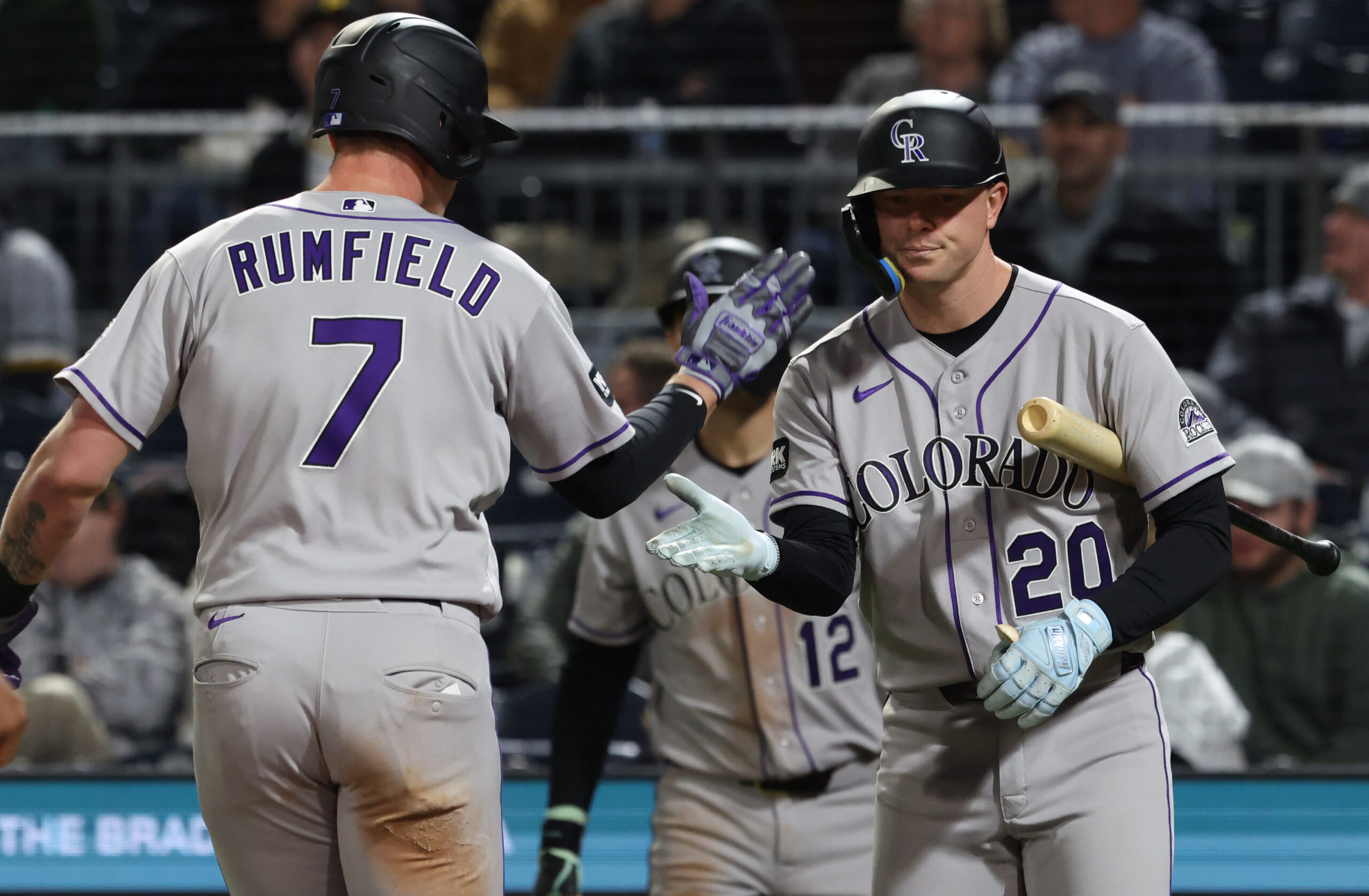 May 13, 2026; Pittsburgh, Pennsylvania, USA; Colorado Rockies first baseman TJ Rumfield (7) celebrates his solo home run with designated hitter Troy Johnston (20) against the Pittsburgh Pirates during the eighth inning at PNC Park. Mandatory Credit: Charles LeClaire-Imagn Images