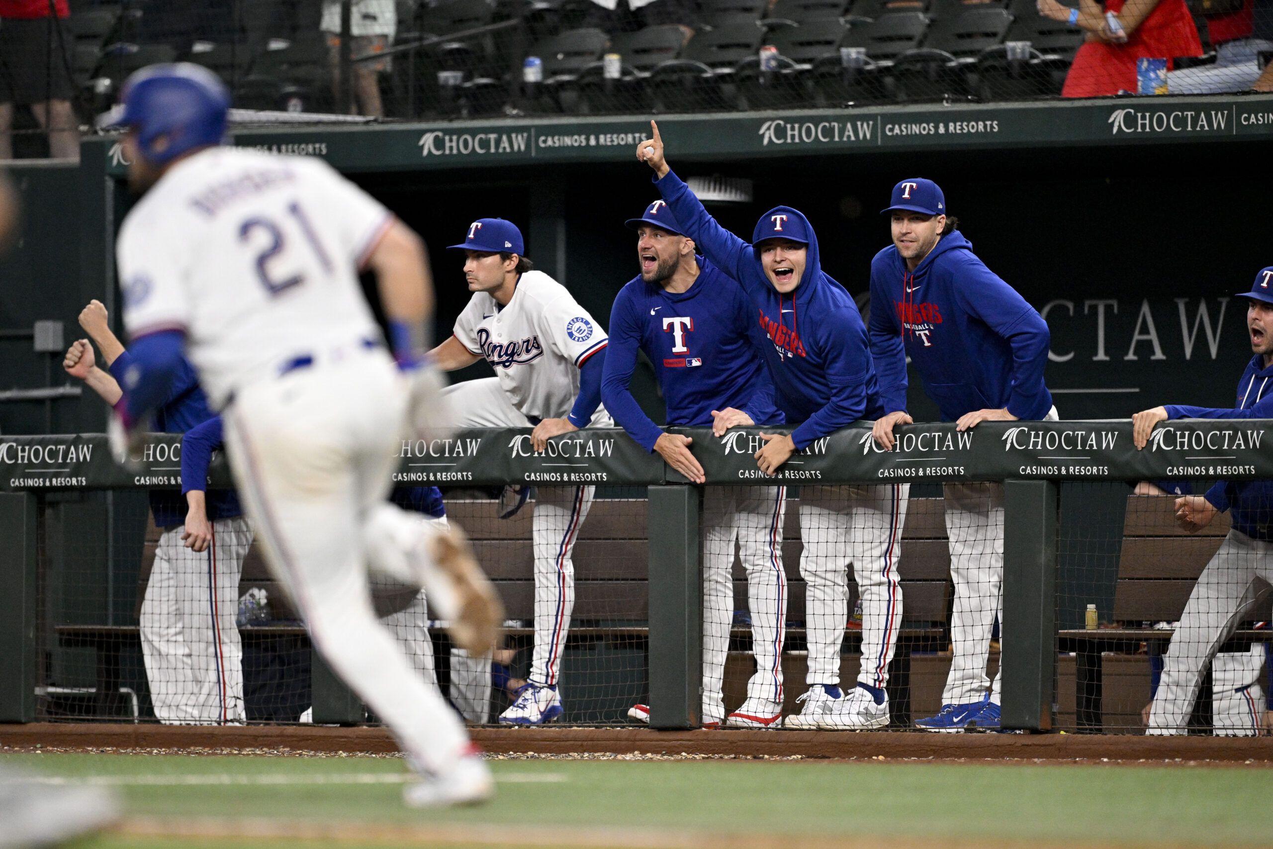 May 13, 2026; Arlington, Texas, USA;  Texas Rangers first baseman Jake Burger (21) hits a single and drives in the tying run against the Arizona Diamondbacks during the ninth inning at Globe Life Field. Mandatory Credit: Jerome Miron-Imagn Images