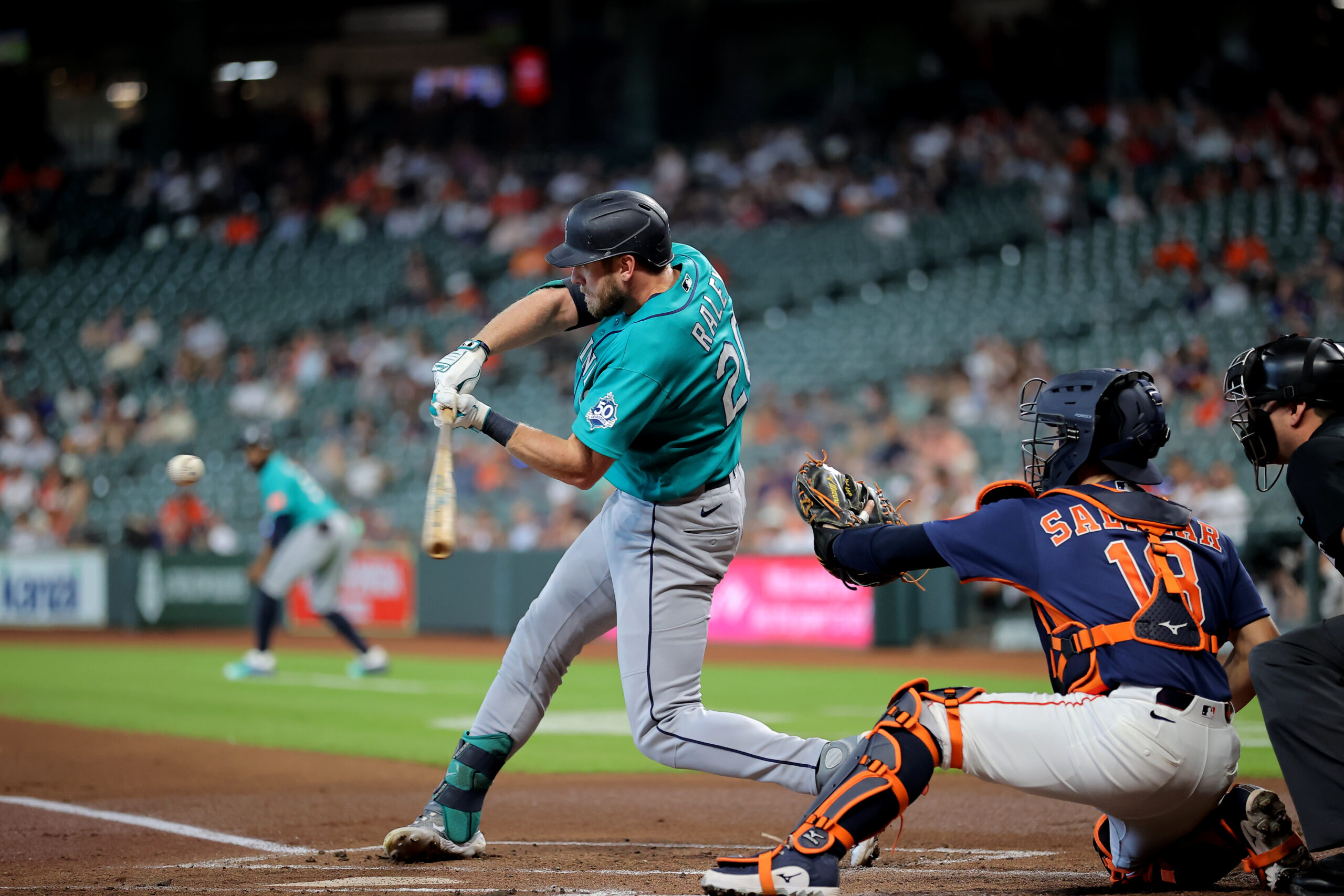 May 14, 2026; Houston, Texas, USA; Seattle Mariners right fielder Luke Raley (20) hits a three-run home run to left field against the Houston Astros during the first inning at Daikin Park. Mandatory Credit: Erik Williams-Imagn Images