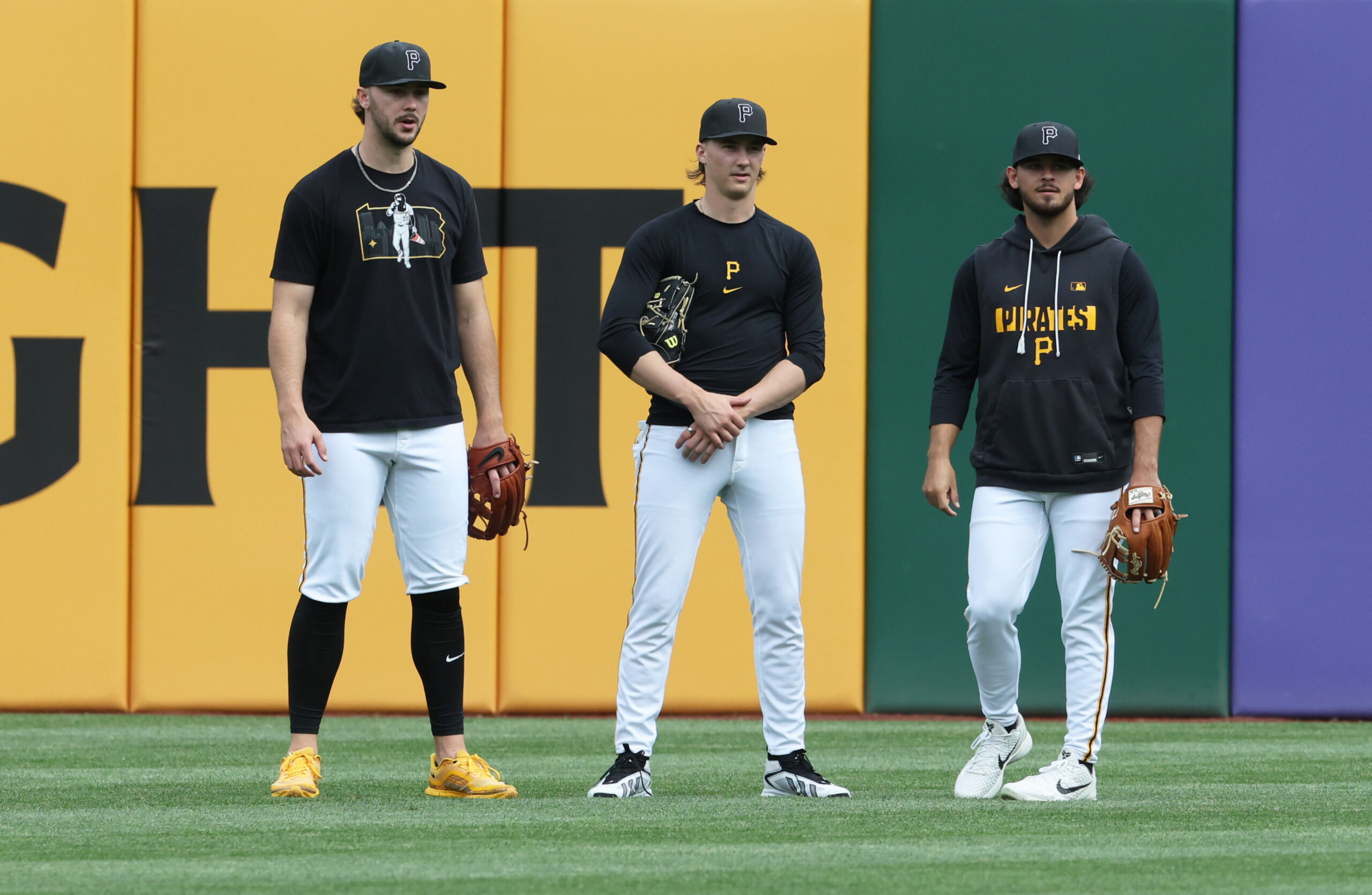 May 15, 2026; Pittsburgh, Pennsylvania, USA;  Pittsburgh Pirates starting pitchers Paul Skenes (left) and Bubba Chandler (middle) and Jared Jones (right) talk in the outfield before the game against the Philadelphia Phillies at PNC Park. Mandatory Credit: Charles LeClaire-Imagn Images