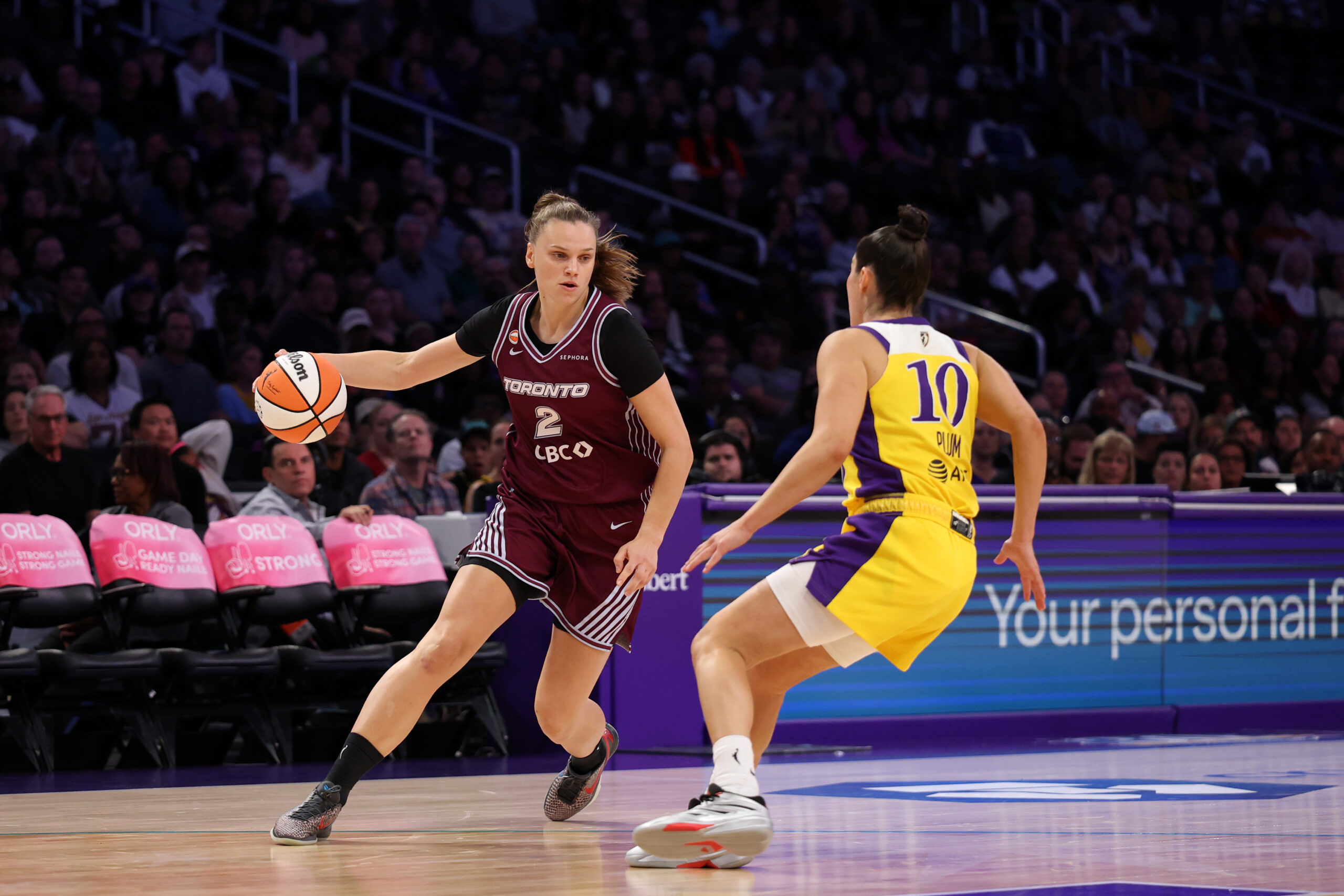May 15, 2026; Los Angeles, California, USA;  Toronto Tempo forward Laura Juskaite (2) dribbles the ball against Los Angeles Sparks guard Kelsey Plum (10) during the second quarter at Crypto.com Arena. Mandatory Credit: Kiyoshi Mio-Imagn Images