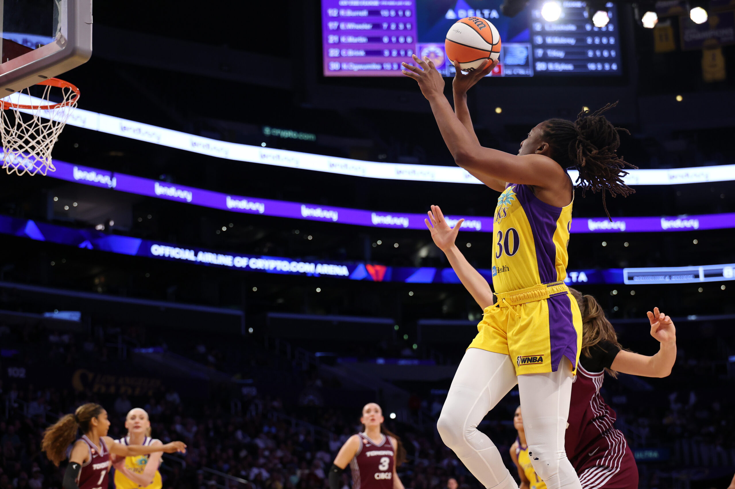 May 15, 2026; Los Angeles, California, USA;  Los Angeles Sparks forward Nneka Ogwumike (30) shoots the ball past Toronto Tempo forward Laura Juskaite (2) during the third quarter at Crypto.com Arena. Mandatory Credit: Kiyoshi Mio-Imagn Images