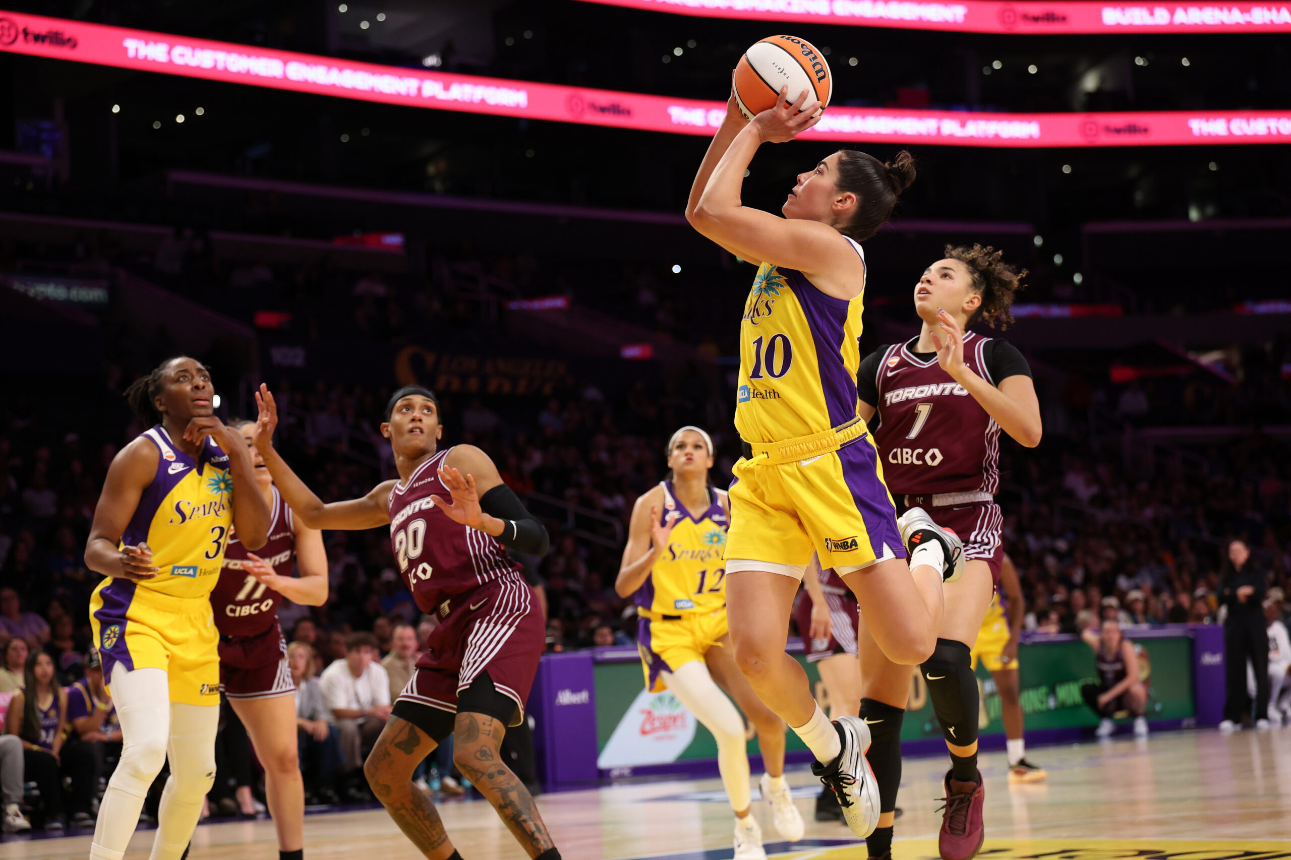 May 15, 2026; Los Angeles, California, USA;  Los Angeles Sparks guard Kelsey Plum (10) shoots the ball past Toronto Tempo guard Kiki Rice (1) during the fourth quarter at Crypto.com Arena. Mandatory Credit: Kiyoshi Mio-Imagn Images