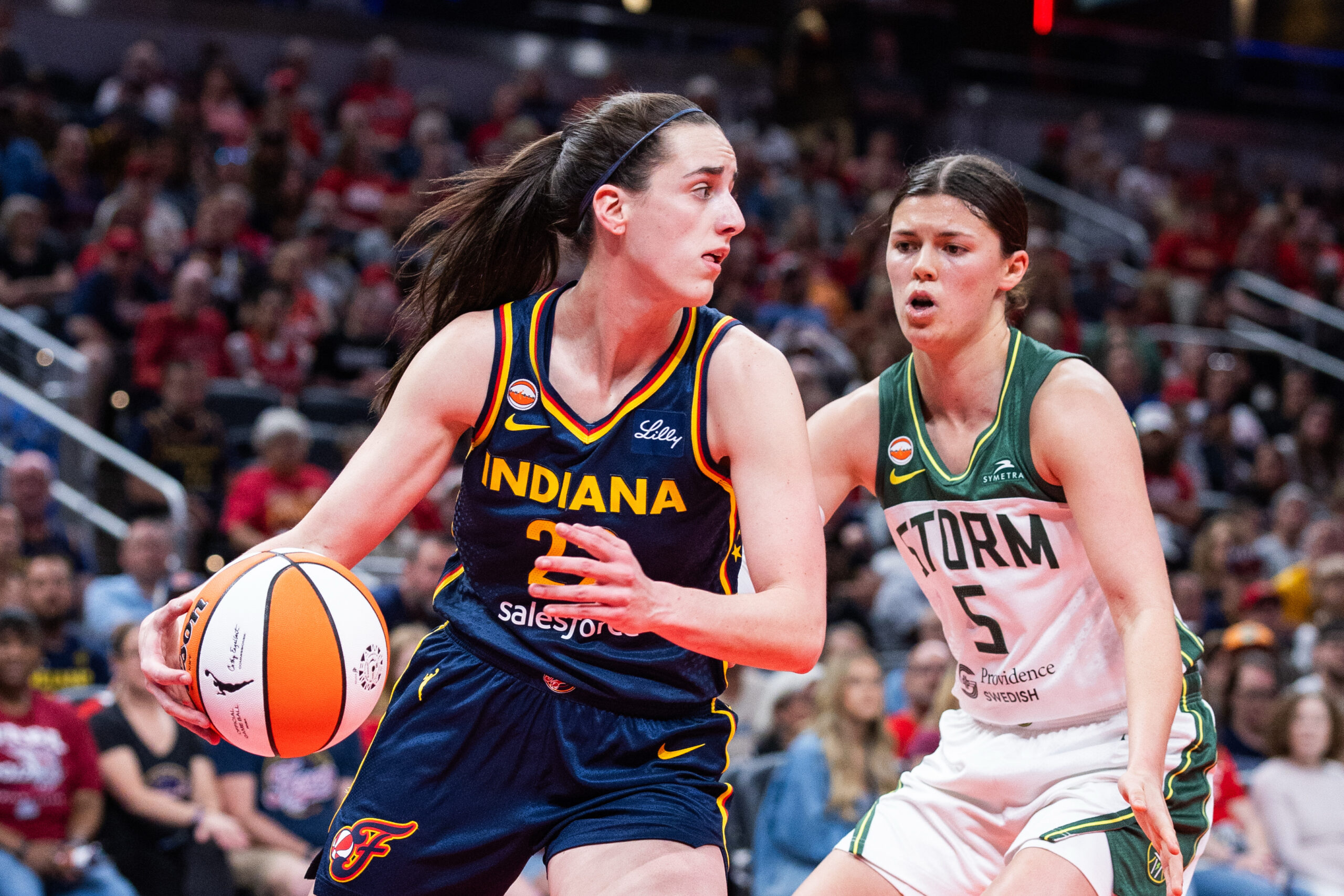 May 17, 2026; Indianapolis, Indiana, USA; Indiana Fever guard Caitlin Clark (22) dribbles against Seattle Storm guard Jade Melbourne (5) in the first half at Gainbridge Fieldhouse. Mandatory Credit: Trevor Ruszkowski-Imagn Images