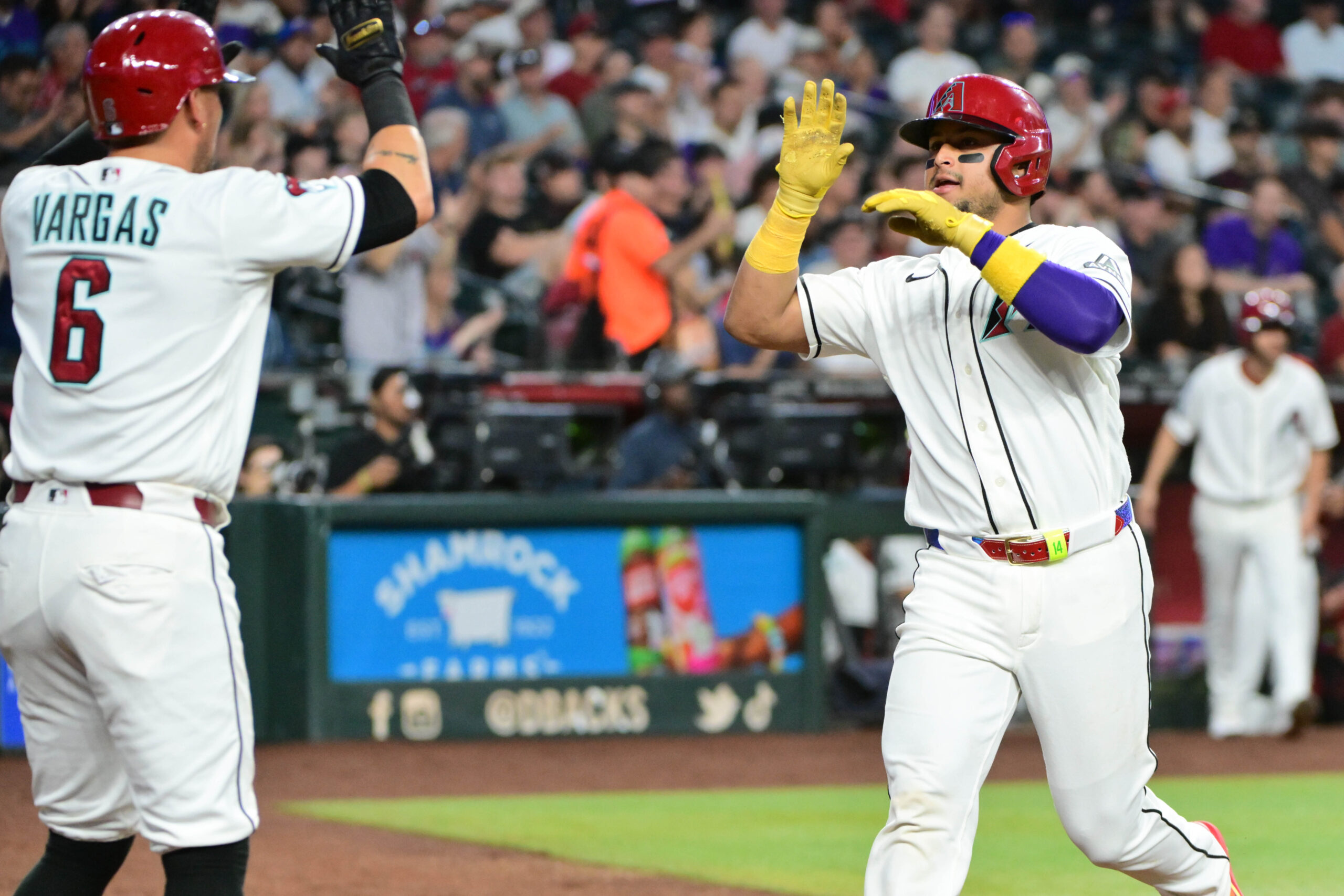 May 18, 2026; Phoenix, Arizona, USA; Arizona Diamondbacks catcher Gabriel Moreno (14) scores and celebrates with first baseman Ildemaro Vargas (6) in the third inning against the San Francisco Giants at Chase Field. Mandatory Credit: Matt Kartozian-Imagn Images