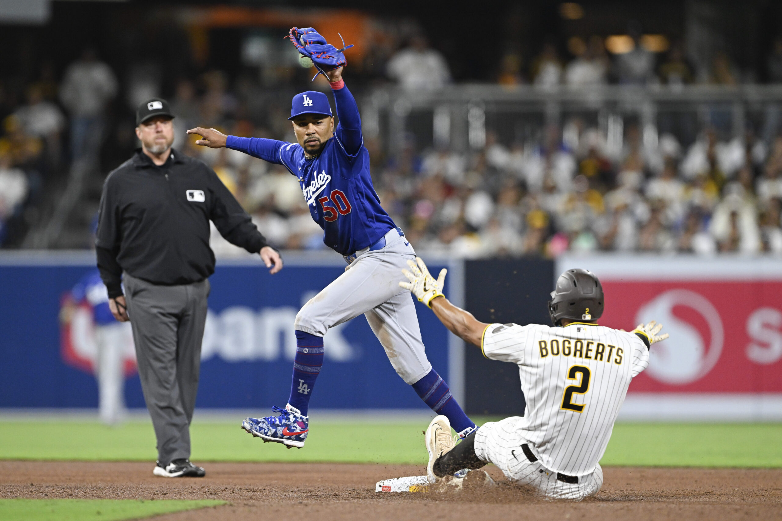 May 18, 2026; San Diego, California, USA; Los Angeles Dodgers shortstop Mookie Betts (50) gets the force out on San Diego Padres shortstop Xander Bogaerts (2) during the seventh inning at Petco Park. Mandatory Credit: Denis Poroy-Imagn Images
