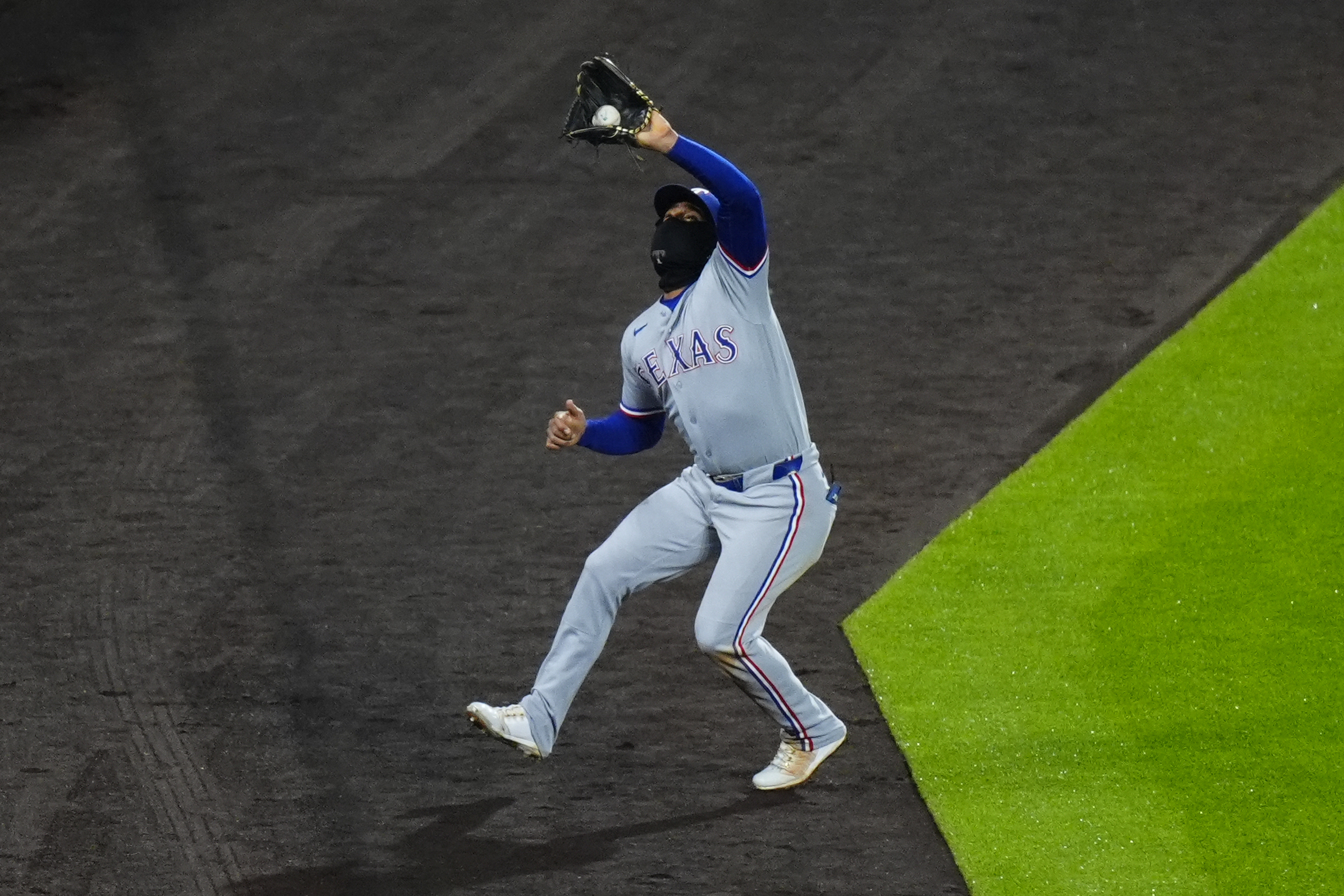 May 19, 2026; Denver, Colorado, USA; Texas Rangers second baseman Ezequiel Duran (20) makes the final out of the ninth inning against the Colorado Rockies at Coors Field. Mandatory Credit: Ron Chenoy-Imagn Images