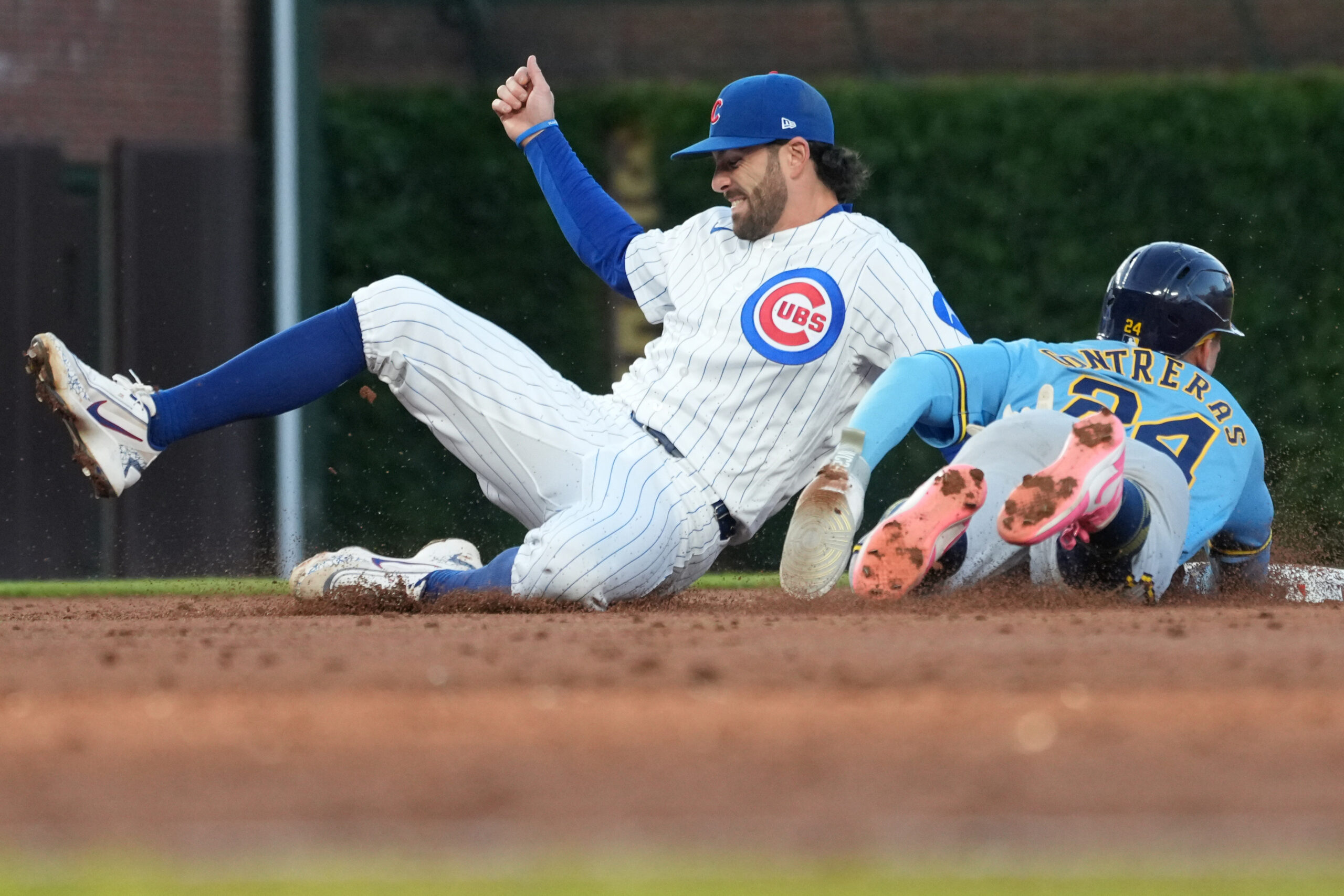 May 20, 2026; Chicago, Illinois, USA; Milwaukee Brewers catcher William Contreras (24) steals second base as Chicago Cubs shortstop Dansby Swanson (7) can’t handle the throw during the third inning at Wrigley Field. Mandatory Credit: David Banks-Imagn Images