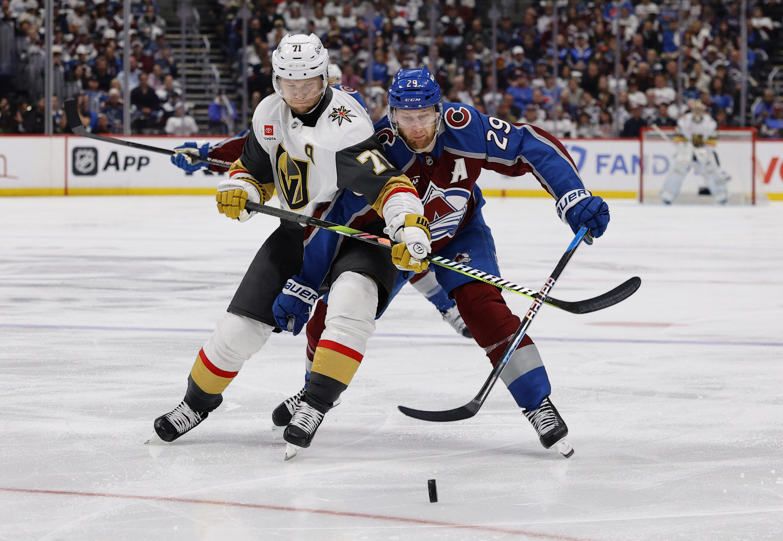 May 20, 2026; Denver, Colorado, USA; Vegas Golden Knights center William Karlsson (71) and Colorado Avalanche center Nathan MacKinnon (29) battle for the puck during the third period in game one of the Western Conference Final of the 2026 Stanley Cup Playoffs at Ball Arena. Mandatory Credit: Isaiah J. Downing-Imagn Images
