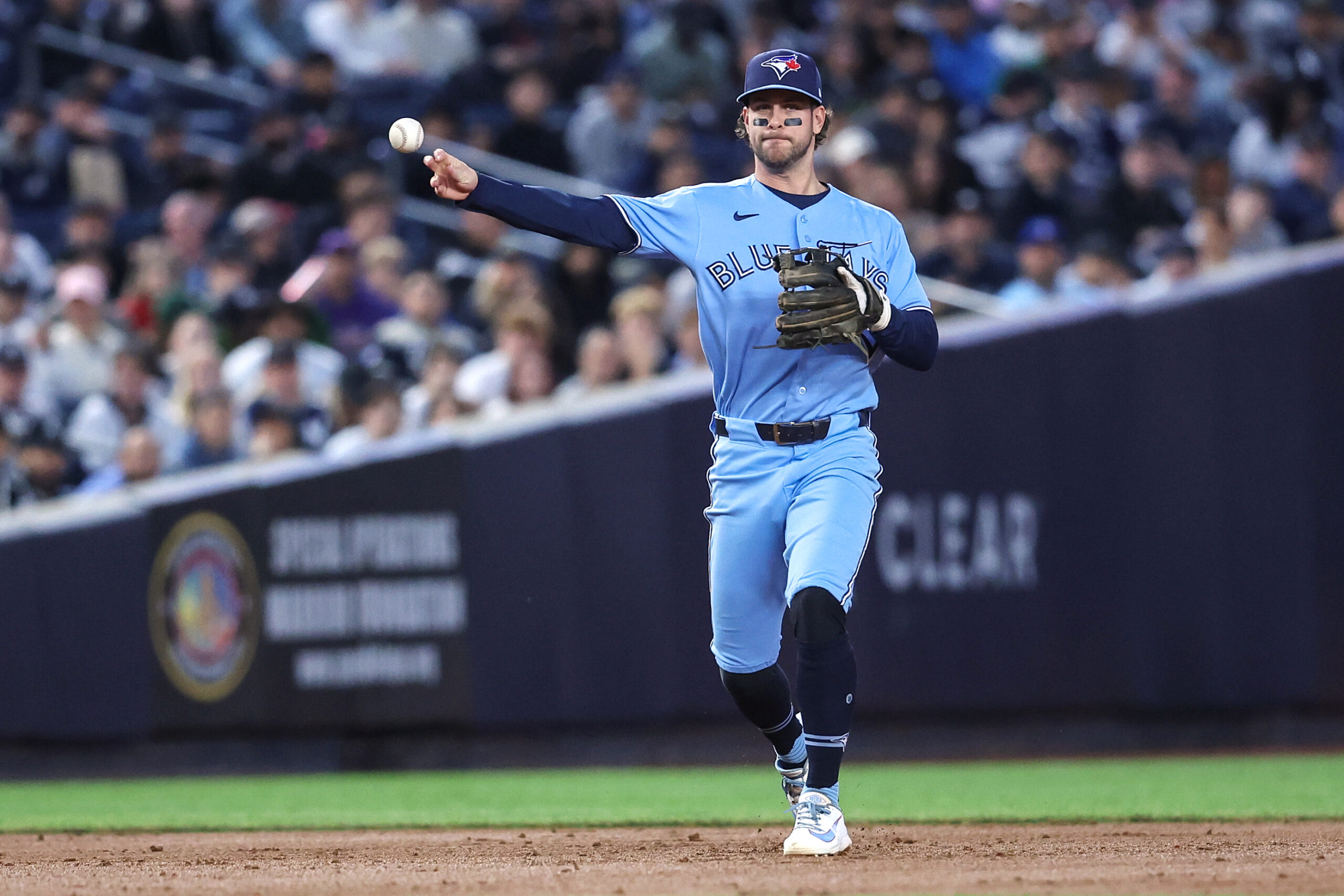 May 21, 2026; Bronx, New York, USA;  Toronto Blue Jays shortstop Ernie Clement (22) throws a runner out at first base in the third inning against the New York Yankees at Yankee Stadium. Mandatory Credit: Wendell Cruz-Imagn Images