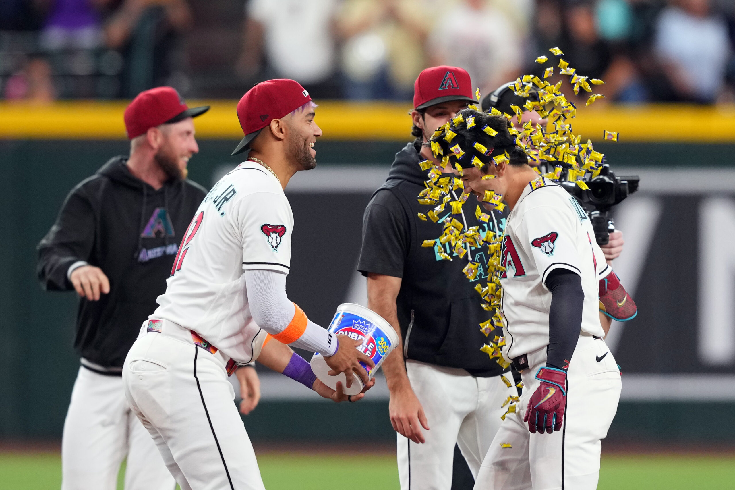 May 21, 2026; Phoenix, Arizona, USA; Arizona Diamondbacks right fielder Corbin Carroll (7) is doused with gum by Arizona Diamondbacks left fielder Lourdes Gurriel Jr. (12) after hitting a walk off single against the Colorado Rockies during the ninth inning at Chase Field. Mandatory Credit: Joe Camporeale-Imagn Images