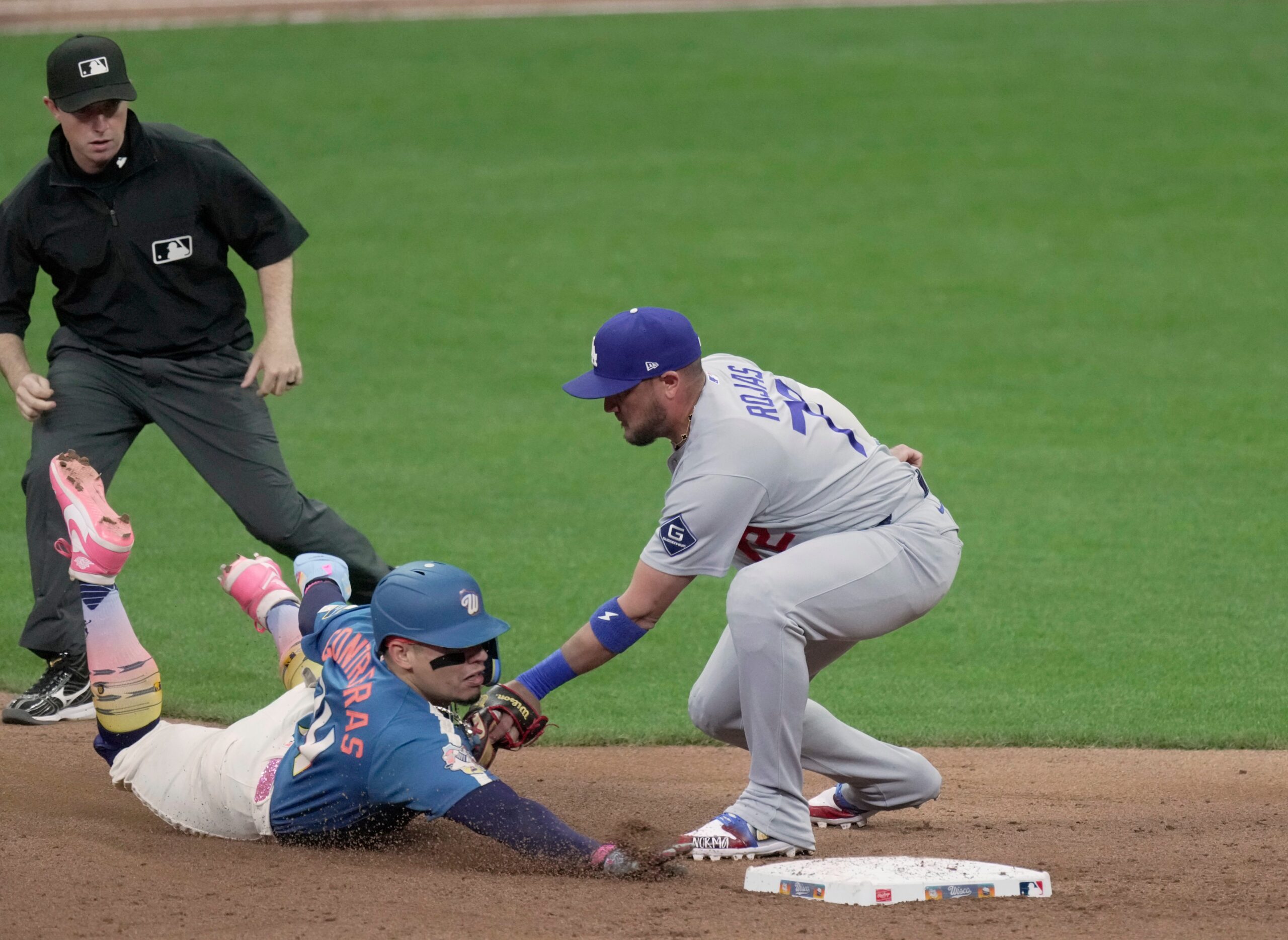 Milwaukee Brewers catcher William Contreras (24) is tagged out by Los Angeles Dodgers shortstop Miguel Rojas (72) while trying to steal second base during the seventh inning of their game Friday, May 22, 2026 at American Family Field in Milwaukee, Wisconsin.
