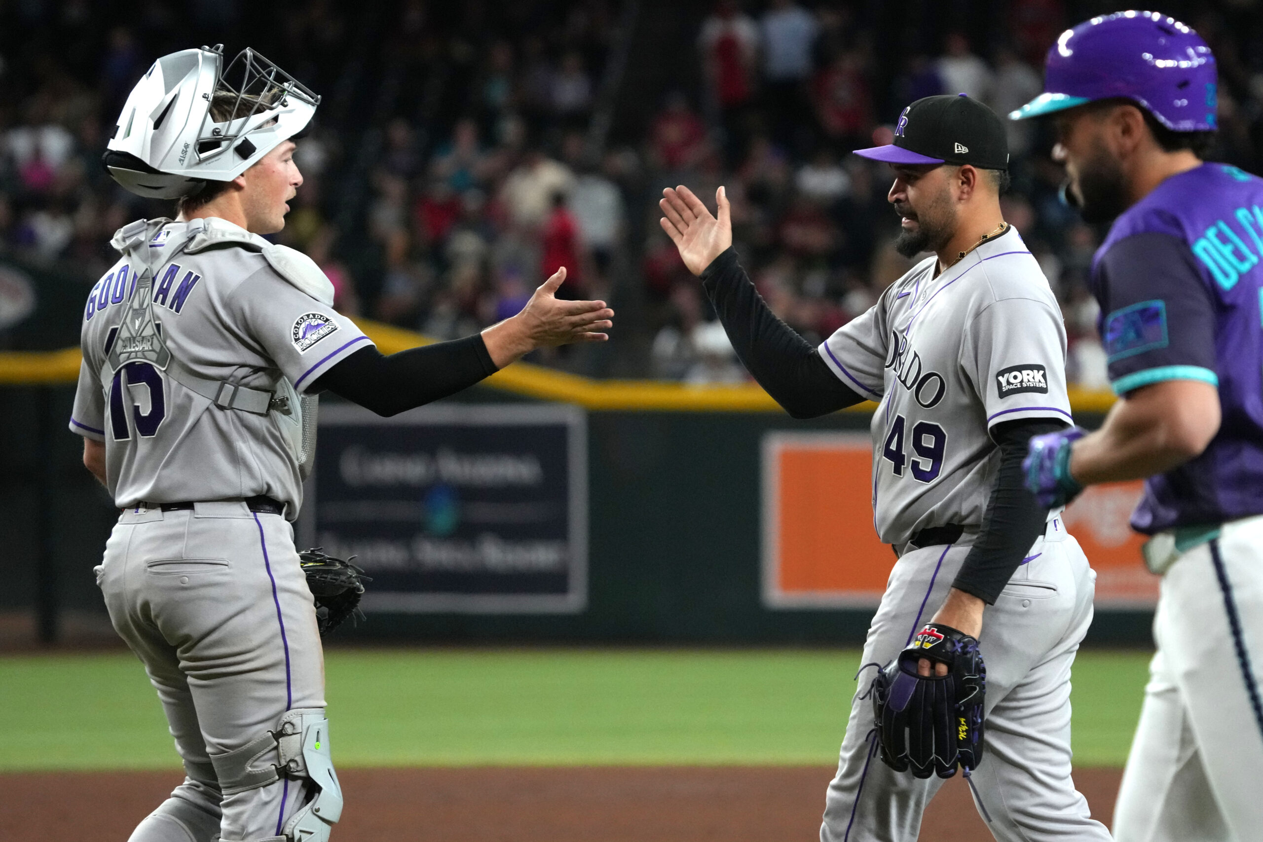 May 22, 2026; Phoenix, Arizona, USA; Colorado Rockies catcher Hunter Goodman (15) and pitcher Antonio Senzatela (49) celebrate after defeating the Arizona Diamondbacks in the fifth inning at Chase Field. Mandatory Credit: Rick Scuteri-Imagn Images