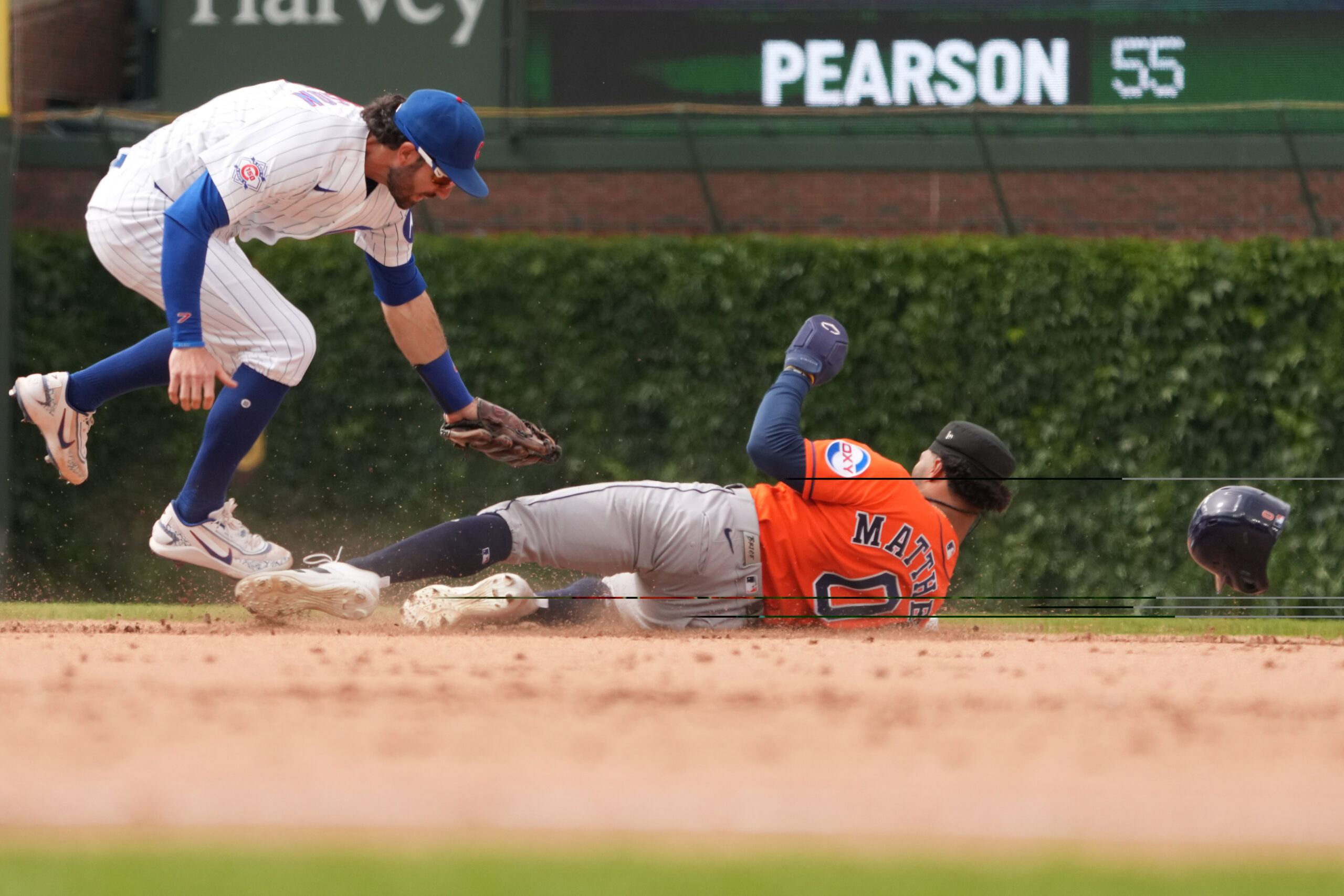 May 23, 2026; Chicago, Illinois, USA; Chicago Cubs shortstop Dansby Swanson (7) tags out Houston Astros center fielder Brice Matthews (0) at second base on a steal attempt during the ninth inning  at Wrigley Field. Mandatory Credit: David Banks-Imagn Images