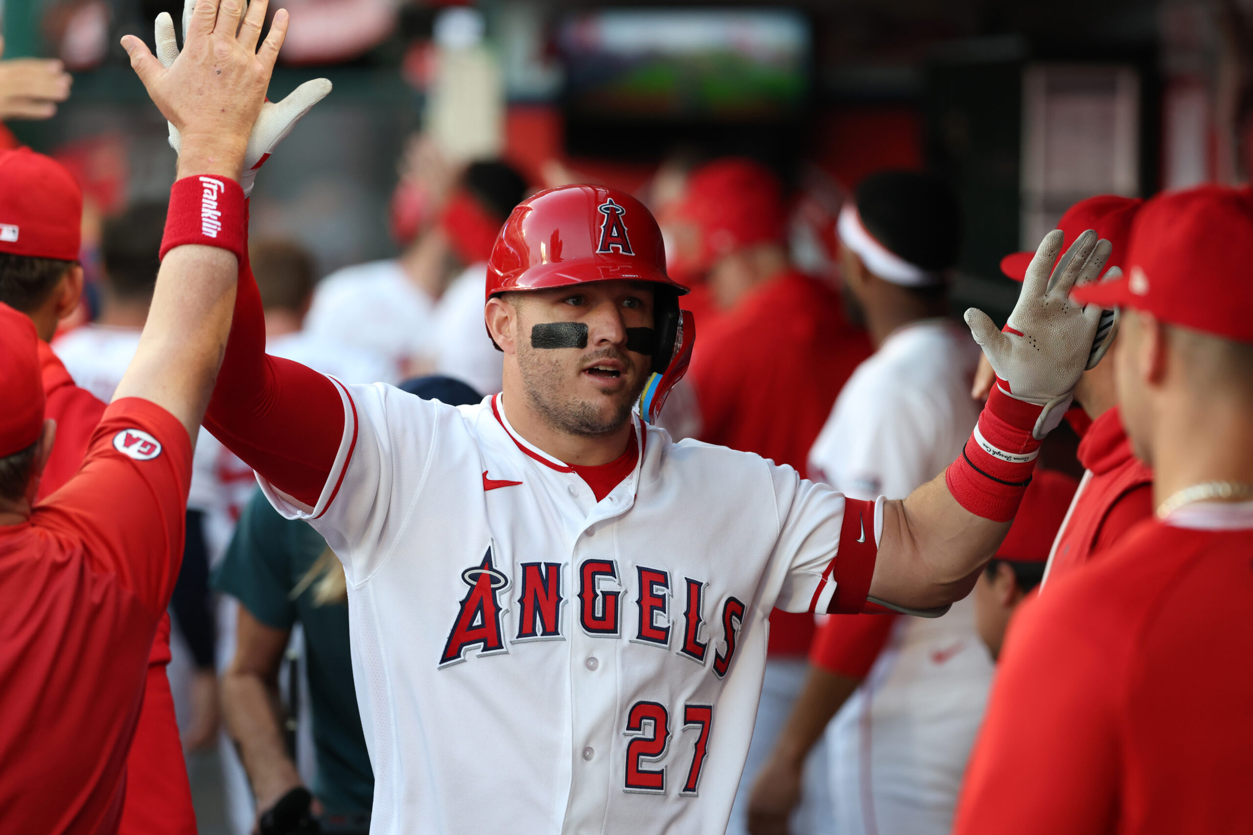 May 23, 2026; Anaheim, California, USA;  Los Angeles Angels center fielder Mike Trout (27) is greeted in the dugout after hitting a two-run home run during the first inning against the Texas Rangers at Angel Stadium. Mandatory Credit: Kiyoshi Mio-Imagn Images