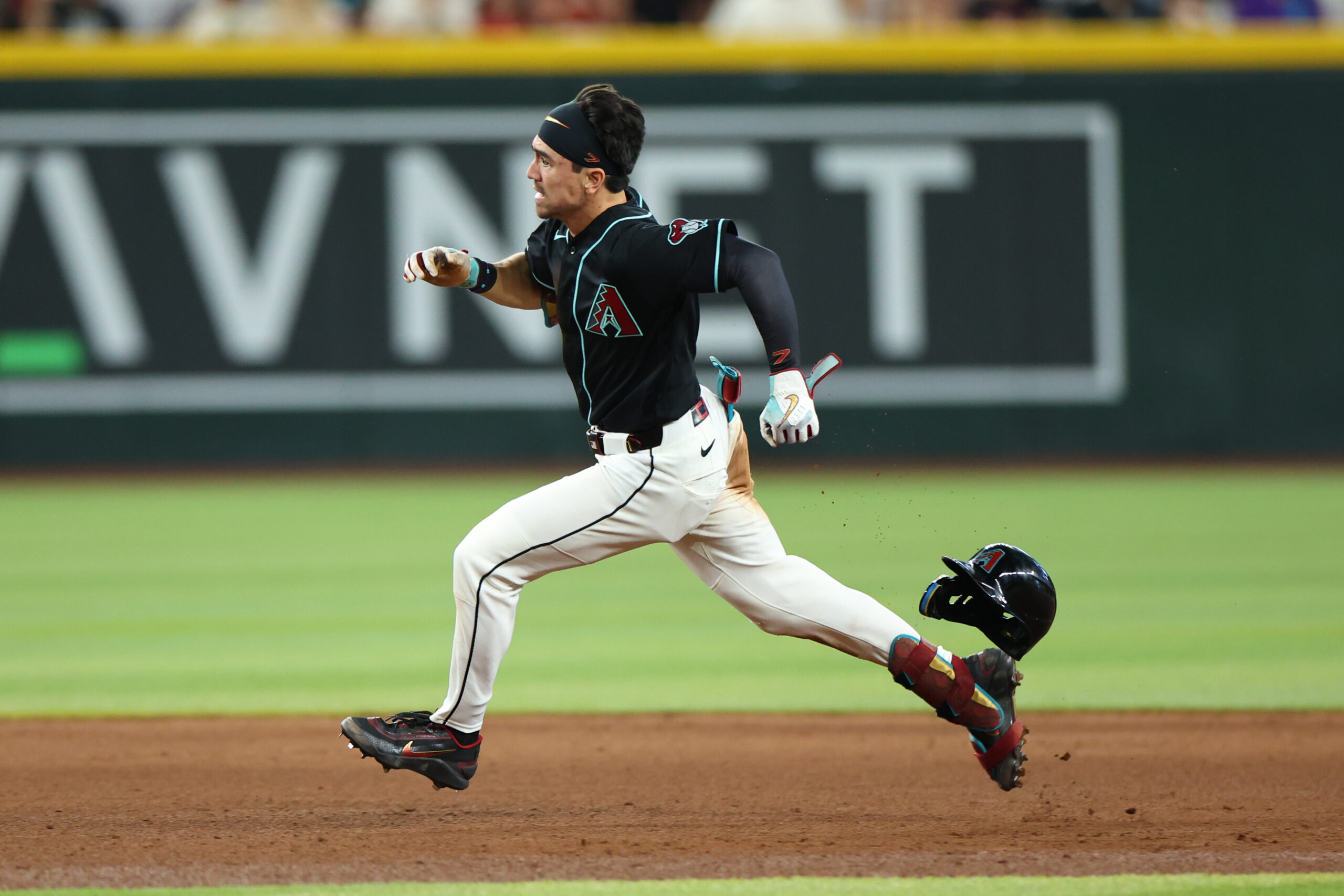 May 24, 2026; Phoenix, Arizona, USA; Arizona Diamondbacks right fielder Corbin Carroll (7) runs while hitting a triple against Colorado Rockies pitcher Seth Halvorsen (54) in the sixth inning at Chase Field. Mandatory Credit: Anna Carrington-Imagn Images