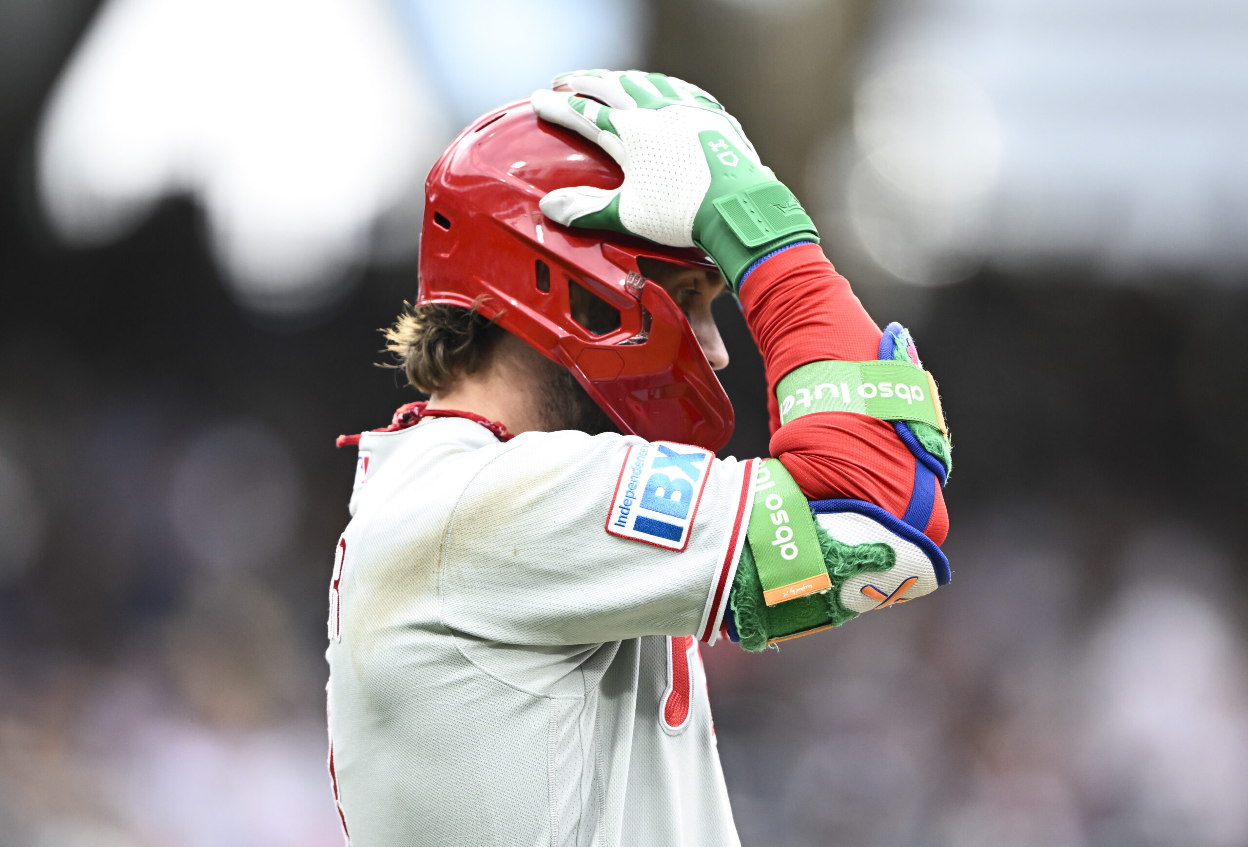 May 25, 2026; San Diego, California, USA; Philadelphia Phillies first baseman Bryce Harper (3) grabs his helmet after hitting a long fly ball during the ninth inning against the San Diego Padres at Petco Park. Mandatory Credit: Denis Poroy-Imagn Images