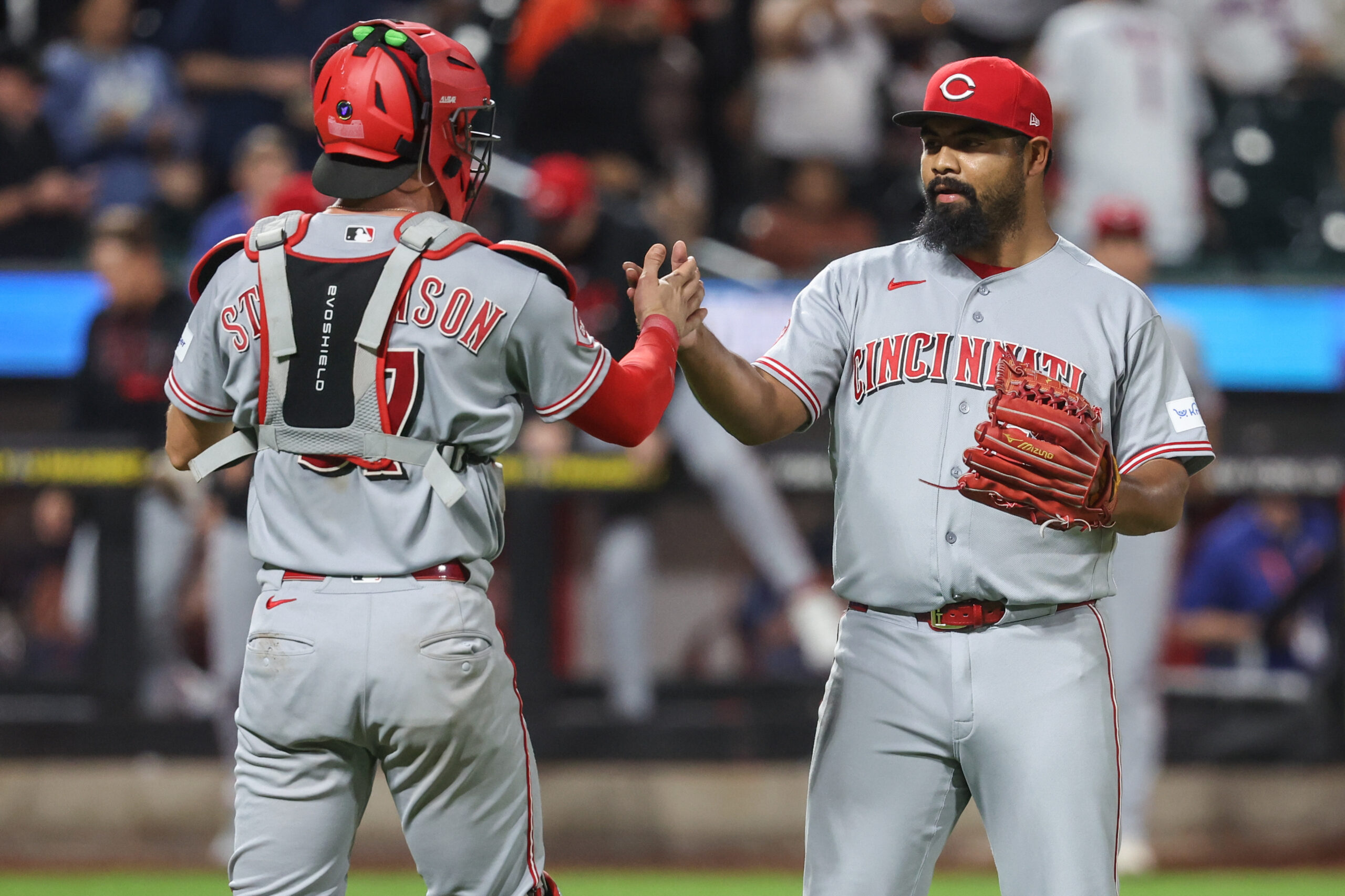 May 26, 2026; New York City, New York, USA;  Cincinnati Reds relief pitcher Tony Santillan (64) and catcher Tyler Stephenson (37) celebrate after defeating the New York Mets 7-2 at Citi Field. Mandatory Credit: Wendell Cruz-Imagn Images