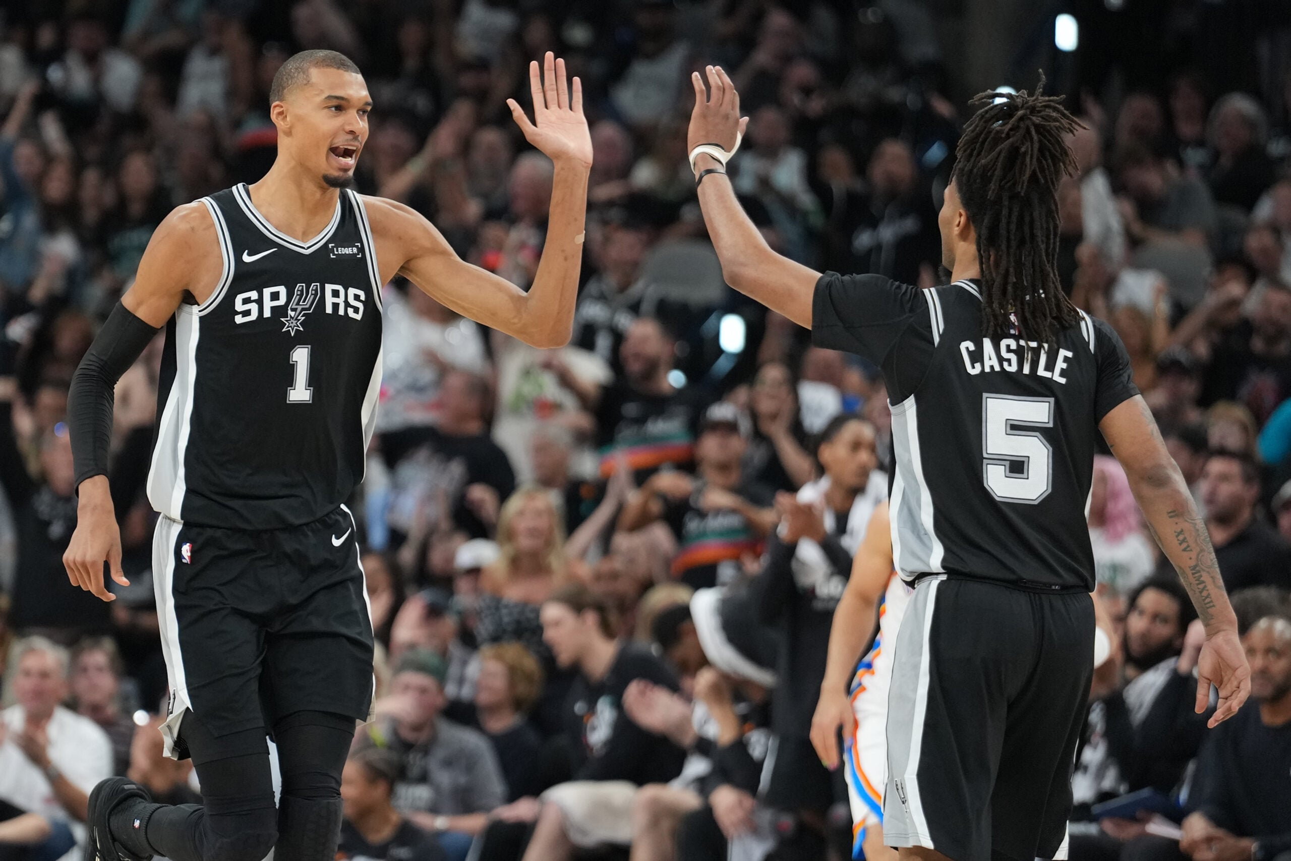 May 28, 2026; San Antonio, Texas, USA; San Antonio Spurs forward Victor Wembanyama (1) reacts with guard Stephon Castle (5) in the second half during game six of the western conference finals for the 2026 NBA playoffs at Frost Bank Center. Mandatory Credit: Daniel Dunn-Imagn Images