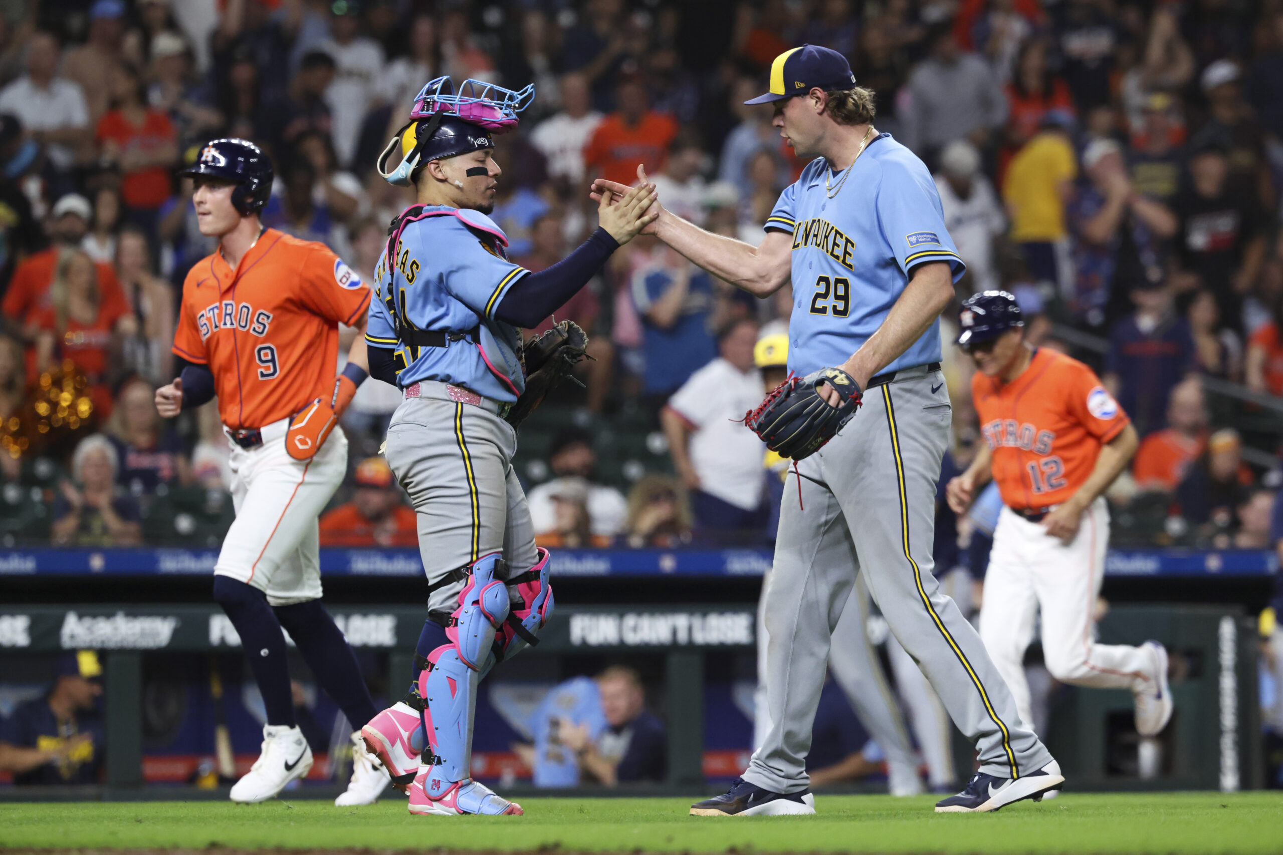 May 29, 2026; Houston, Texas, USA; Milwaukee Brewers catcher William Contreras (24) and pitcher Trevor Megill (29) celebrate after the game against the Houston Astros at Daikin Park. Mandatory Credit: Troy Taormina-Imagn Images