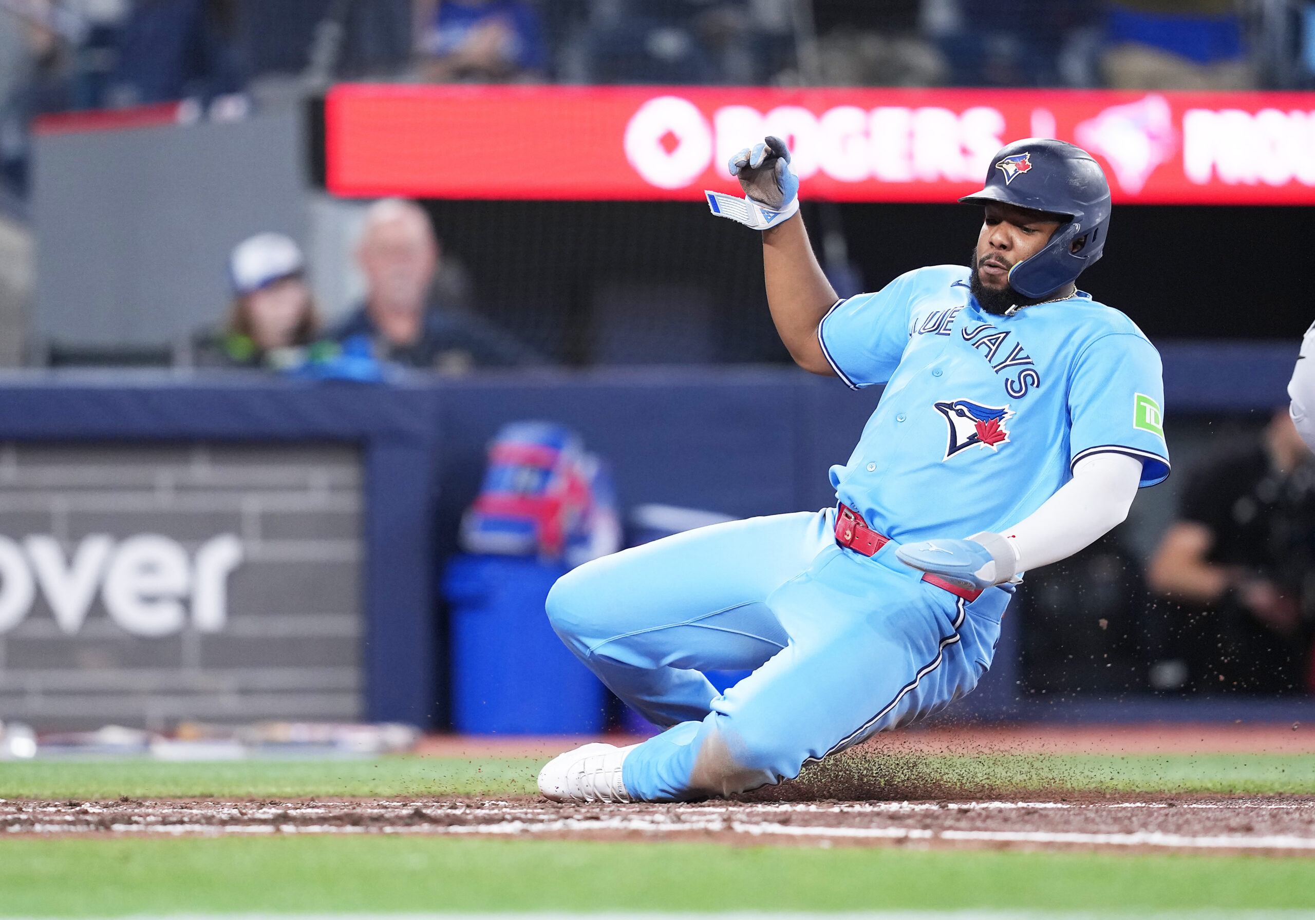 May 24, 2026; Toronto, Ontario, CAN; Toronto Blue Jays first baseman Vladimir Guerrero Jr. (27) slides into home plate scoring a run against the Pittsburgh Pirates during the fourth inning at Rogers Centre. Mandatory Credit: Nick Turchiaro-Imagn Images