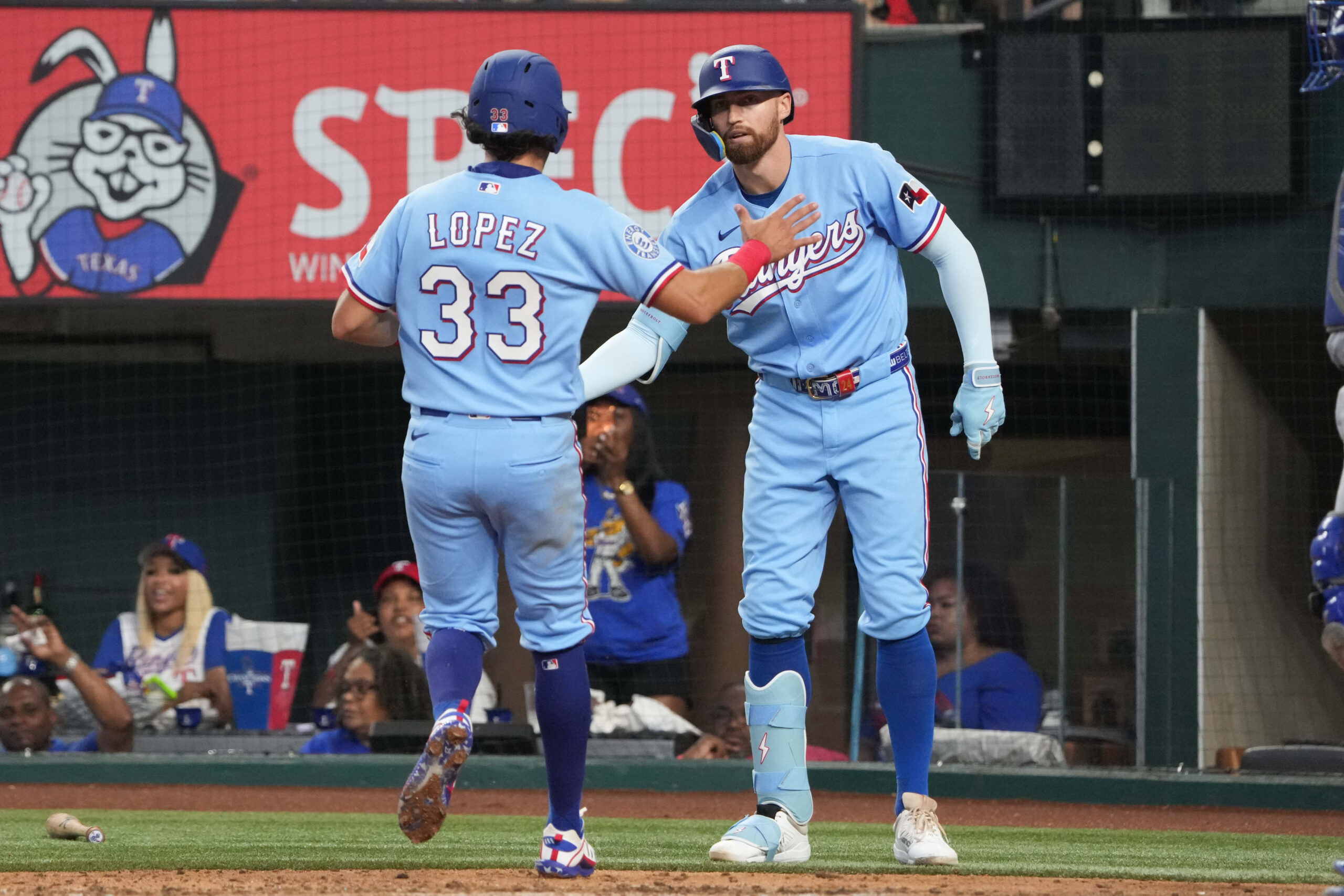 May 31, 2026; Arlington, Texas, USA; Texas Rangers second baseman Nicky Lopez (33) and Brandon Nimmo (24) celebrate scoring against the Kansas City Royals during the fourth inning at Globe Life Field. Mandatory Credit: Jim Cowsert-Imagn Images