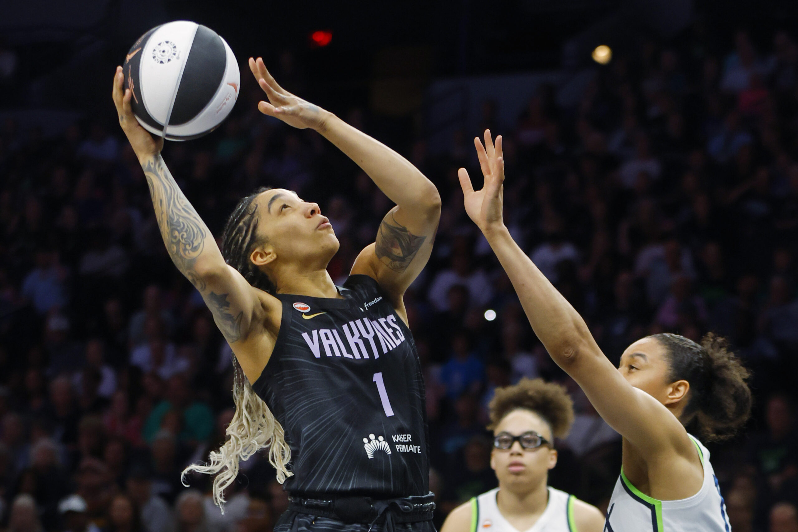 Jun 4, 2026; Minneapolis, Minnesota, USA; Golden State Valkyries forward Gabby Williams (1) shoots the ball against  Minnesota Lynx forward Nia Coffey (12) in the first quarter at Target Center. Mandatory Credit: Bruce Kluckhohn-Imagn Images