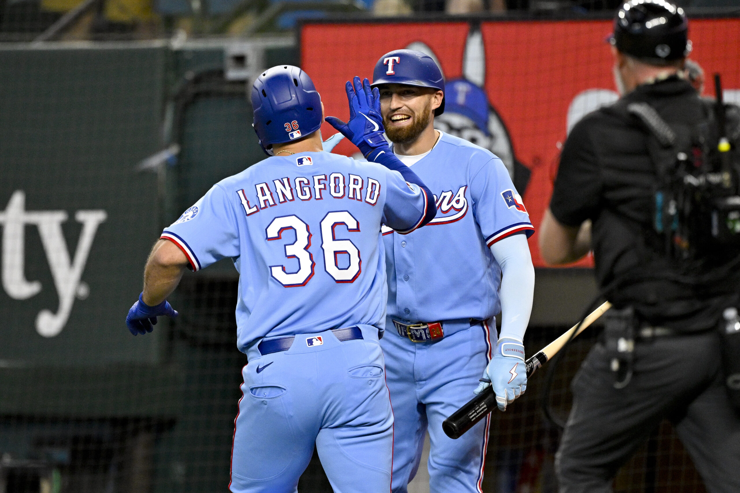 Jun 7, 2026; Arlington, Texas, USA; Texas Rangers left fielder Wyatt Langford (36) and right fielder Brandon Nimmo (24) celebrate after Langford hits a home run against the Cleveland Guardians during the fourth inning at Globe Life Field. Mandatory Credit: Jerome Miron-Imagn Images