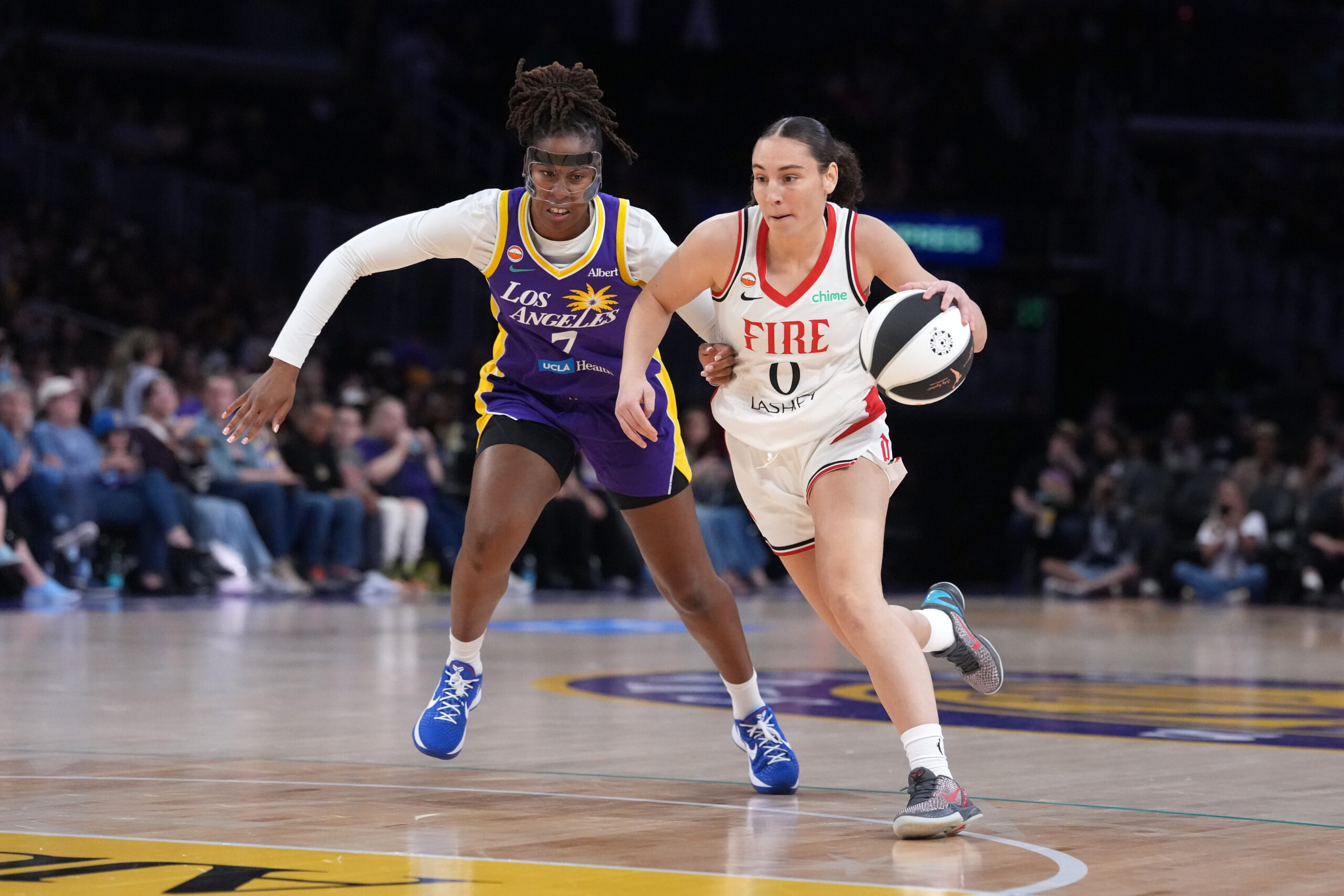 Jun 7, 2026; Los Angeles, California, USA; Portland Fire guard Carla Leite (0) drives to the basket against LA Sparks guard Ariel Atkins (7) in the first half at Crypto.com Arena. Mandatory Credit: Kirby Lee-Imagn Images