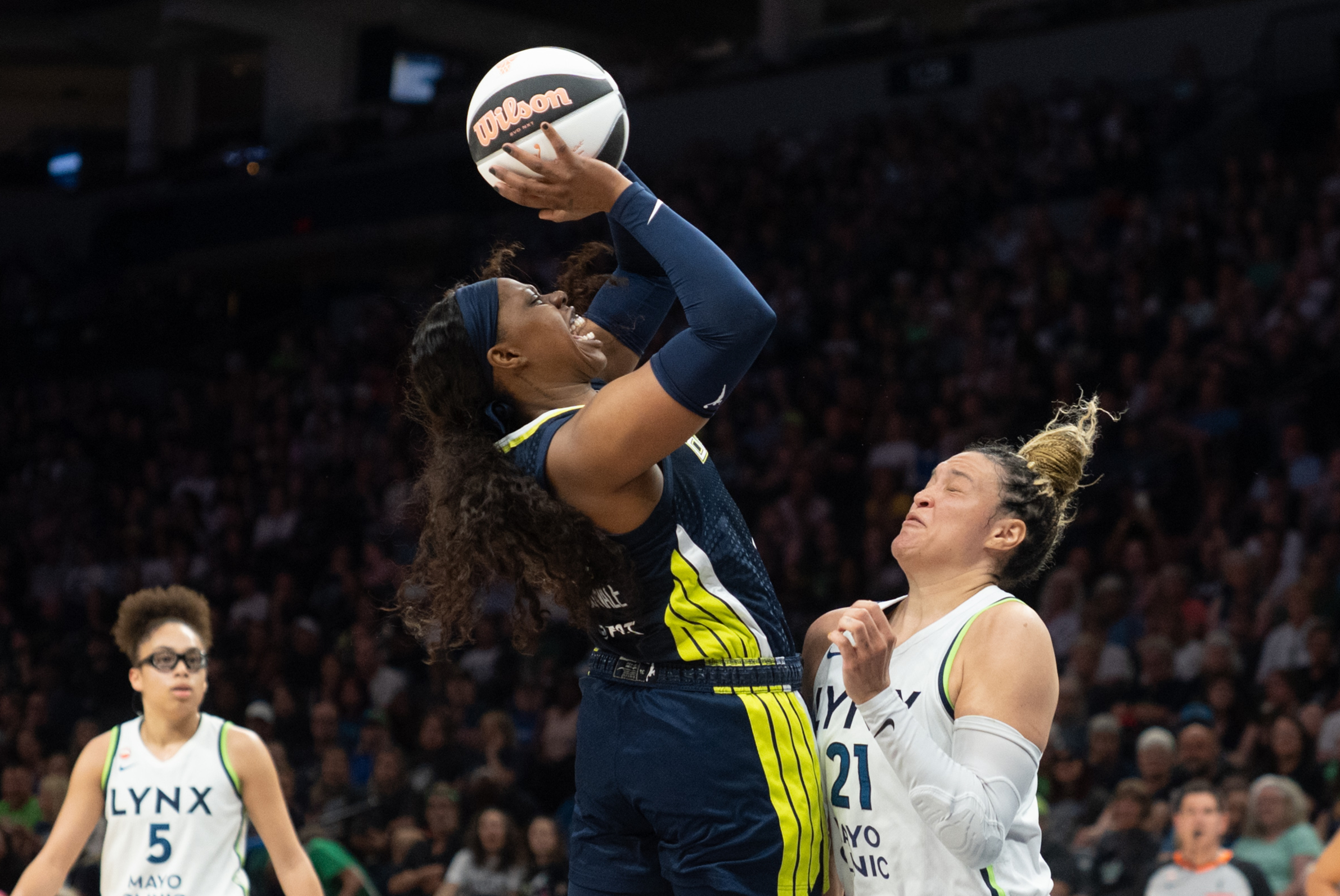 Jun 9, 2026; Minneapolis, Minnesota, USA; Dallas Wings guard Arike Ogunbowale (24) and Minnesota Lynx guard Kayla McBride (21) collide in the second quarter at Target Center. Mandatory Credit: Matt Blewett-Imagn Images