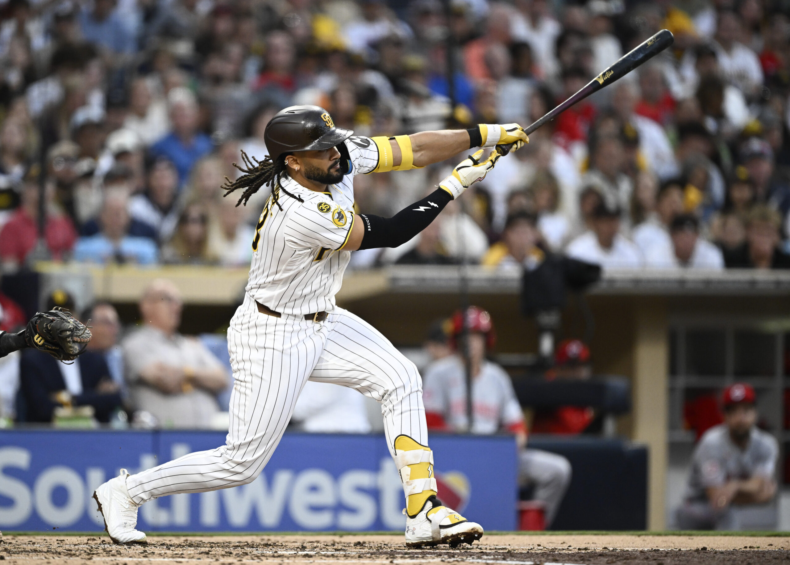 Jun 9, 2026; San Diego, California, USA; San Diego Padres second baseman Fernando Tatis Jr. (23) hits a single during the third inning against the Cincinnati Reds at Petco Park. Mandatory Credit: Denis Poroy-Imagn Images