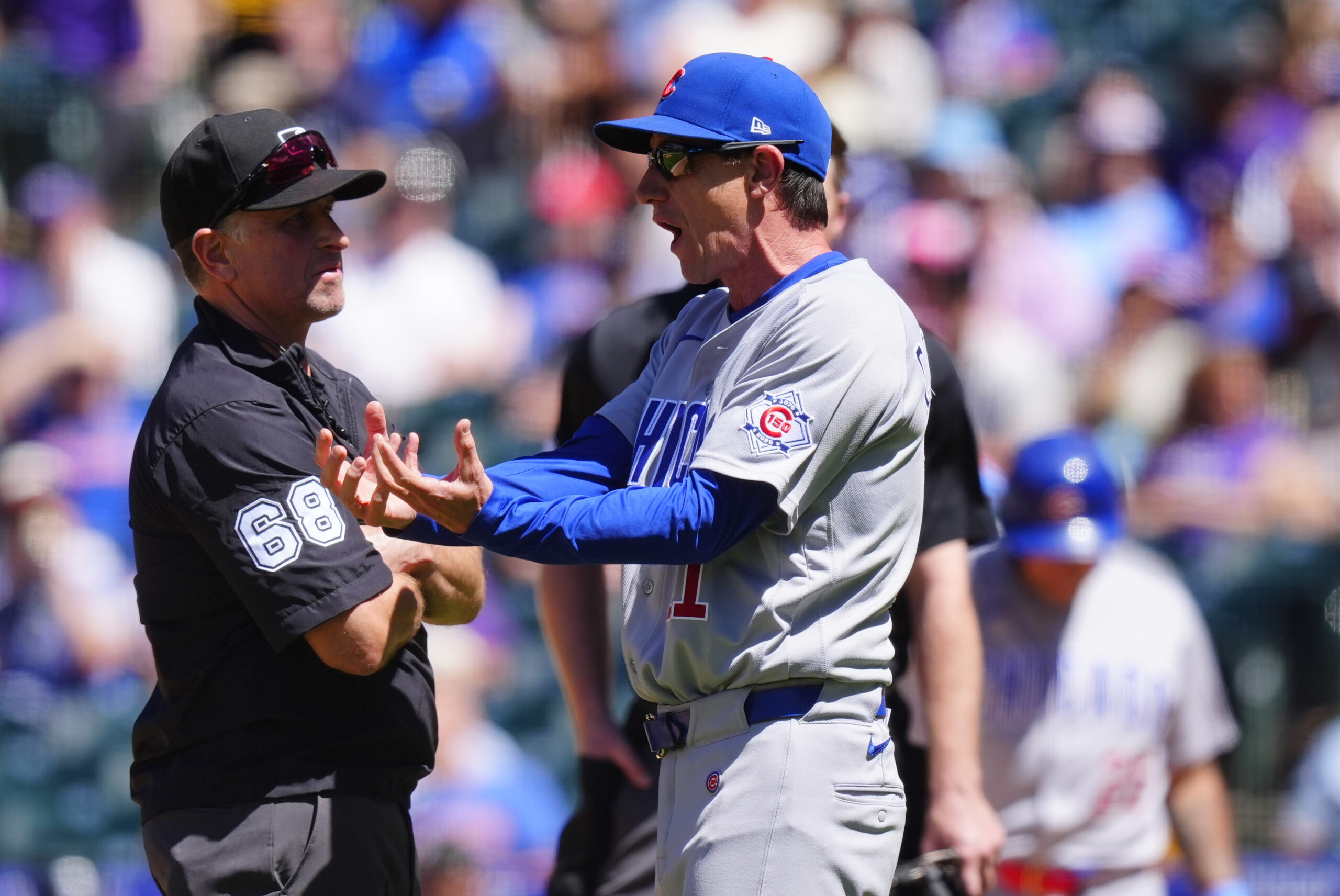 Jun 11, 2026; Denver, Colorado, USA; MLB second base umpire Chris Guccione (68) listens to Chicago Cubs manager Craig Counsell (11) in the sixth inning against the Colorado Rockiesat Coors Field. Mandatory Credit: Ron Chenoy-Imagn Images