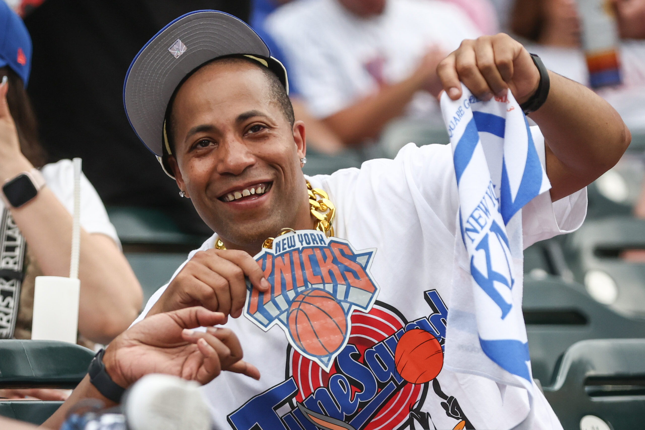 Jun 14, 2026; New York City, New York, USA; A fan at the game between the Atlanta Braves and New York Mets celebrates the New York Knicks winning the NBA Finals at Citi Field. Mandatory Credit: Wendell Cruz-Imagn Images