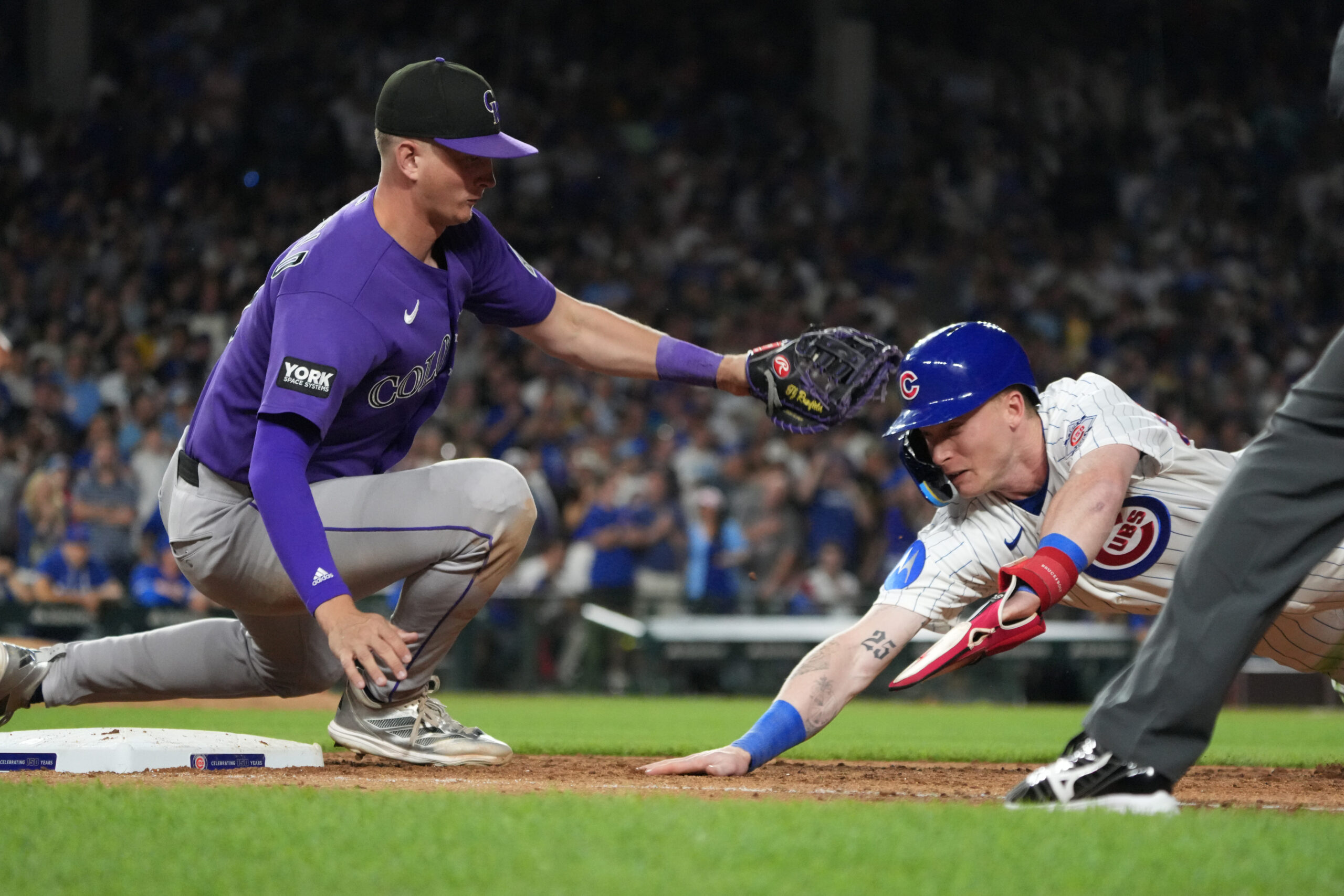 Jun 15, 2026; Chicago, Illinois, USA; Chicago Cubs center fielder Pete Crow-Armstrong (4) is tagged out at first base by Colorado Rockies first baseman TJ Rumfield (7) on a pick-off during the seventh inning Wrigley Field. Mandatory Credit: David Banks-Imagn Images