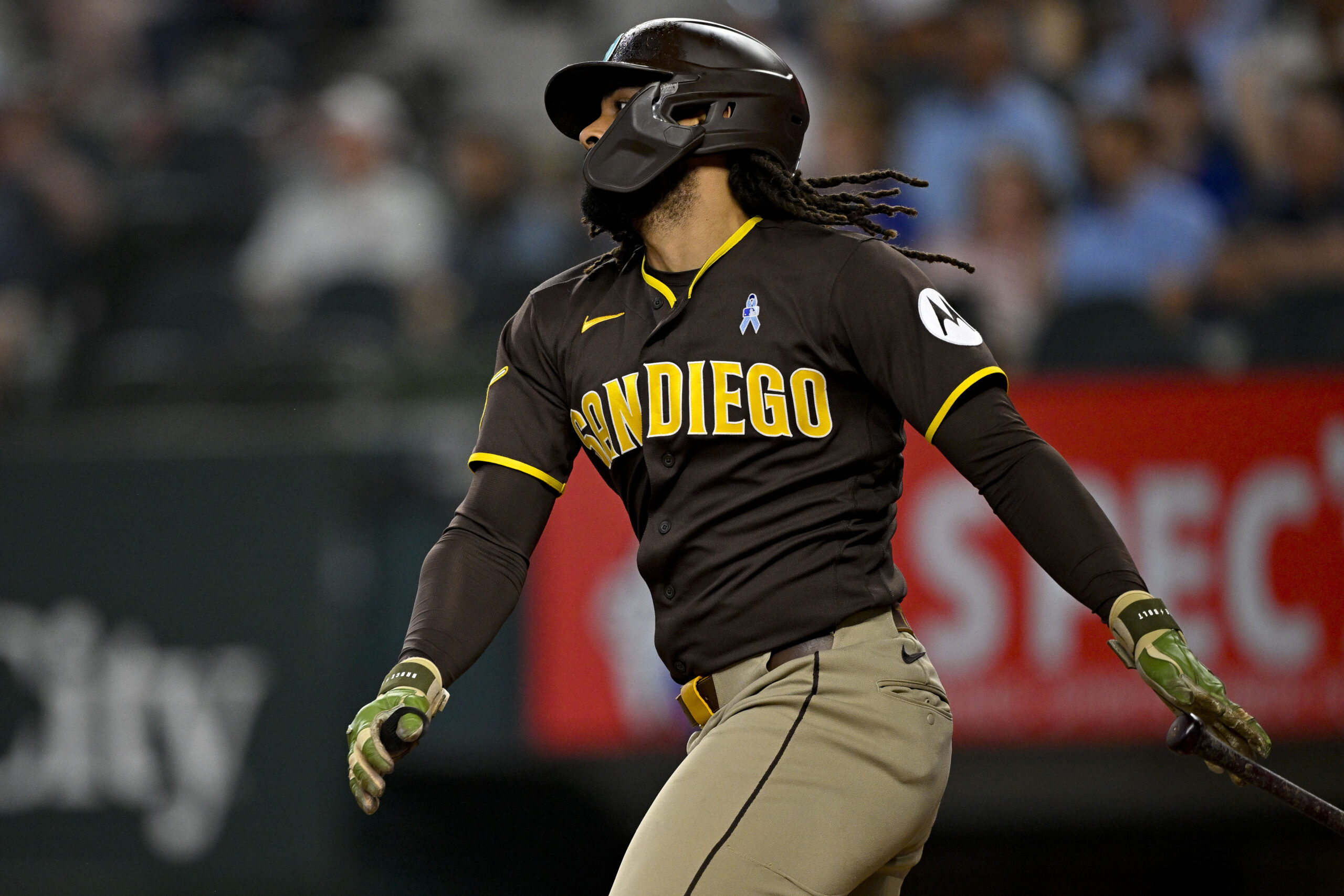 Jun 21, 2026; Arlington, Texas, USA; San Diego Padres pinch hitter Fernando Tatis Jr. (23) hits a single against the Texas Rangers during the ninth inning at Globe Life Field. Mandatory Credit: Jerome Miron-Imagn Images