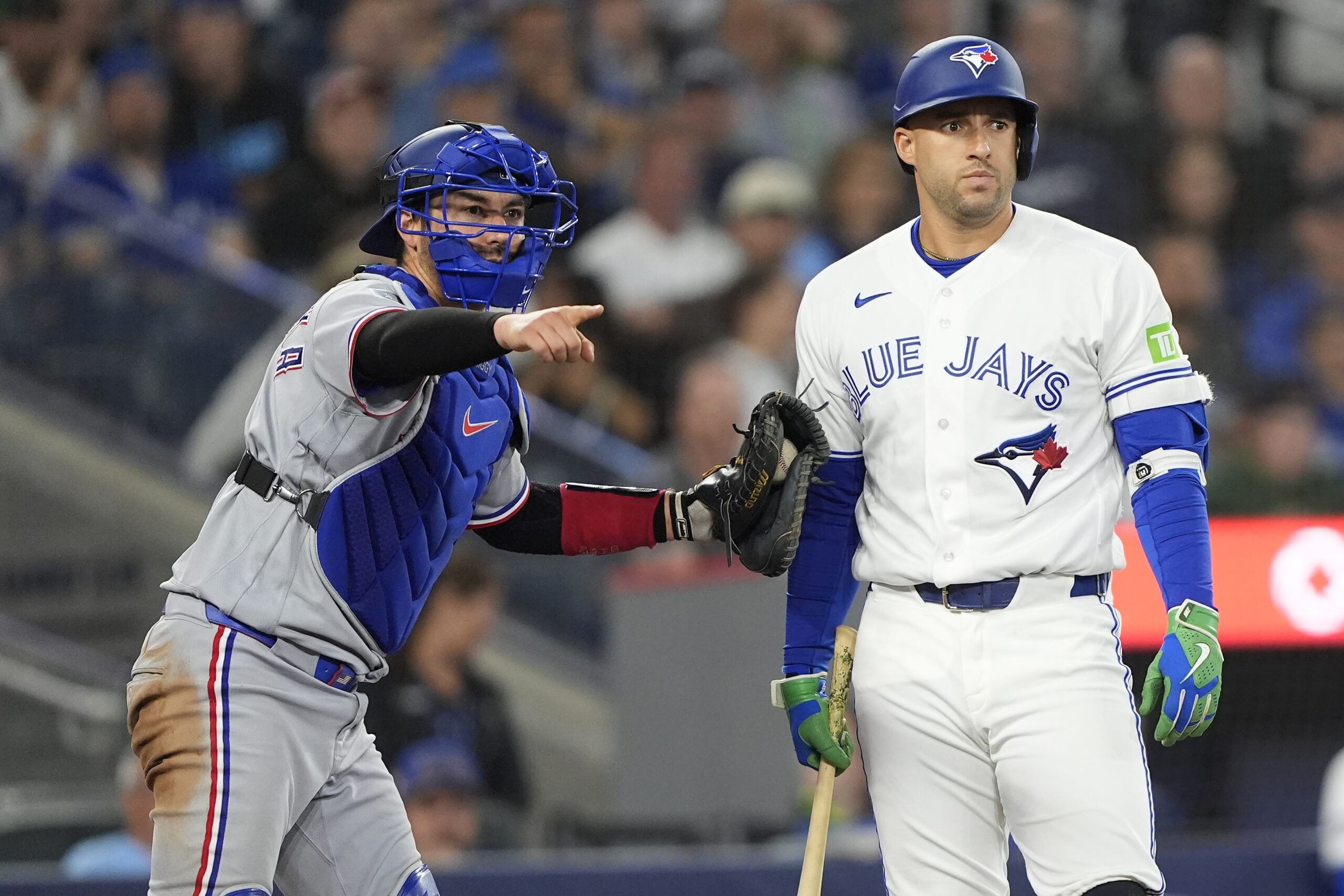 Jun 25, 2026; Toronto, Ontario, CAN; Texas Rangers catcher Kyle Higashioka (11) loks for a strike call against Toronto Blue Jays designated hitter George Springer (4) during the eighth inning at Rogers Centre. Mandatory Credit: John E. Sokolowski-Imagn Images