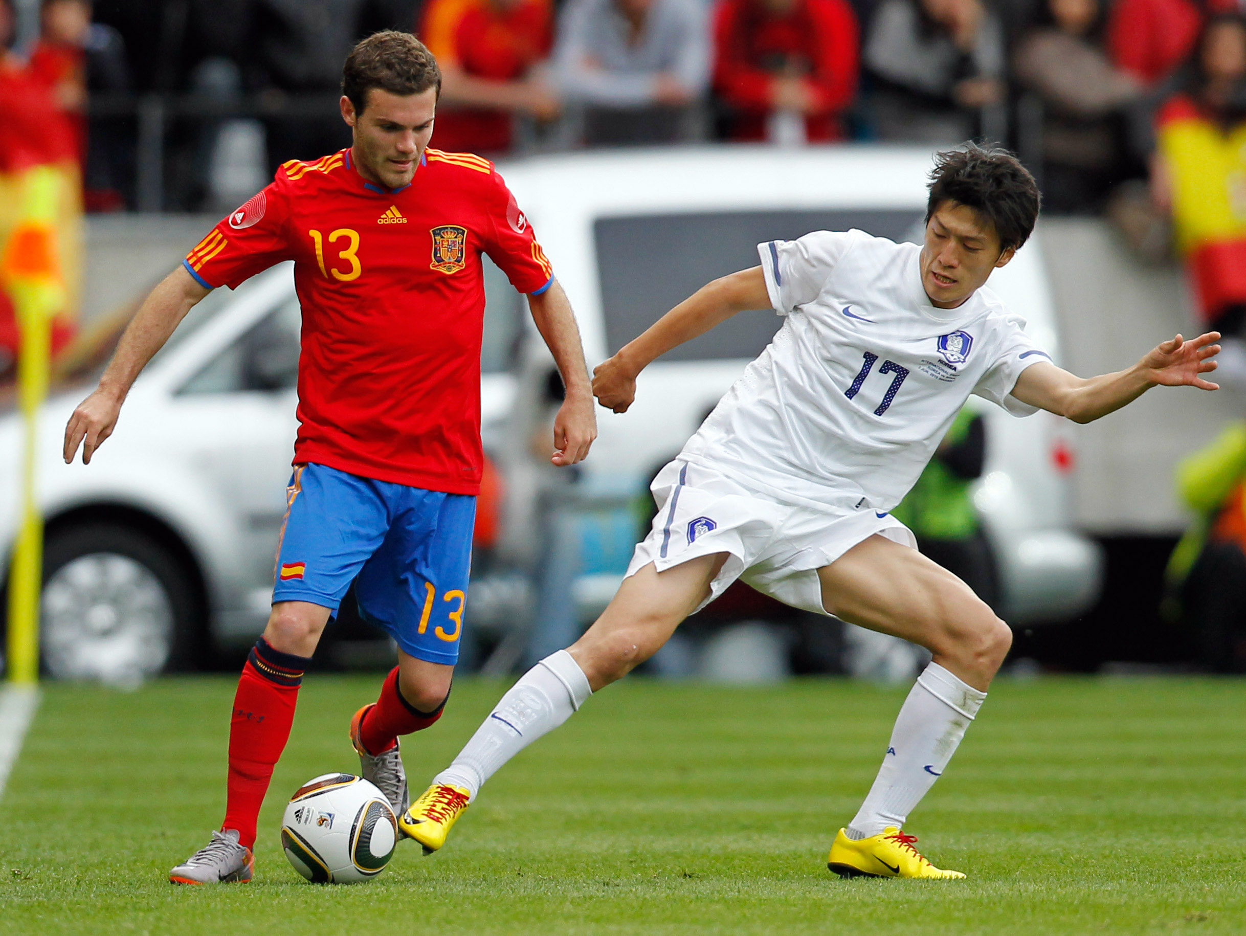 June 3, 2010; Innsbruck, AUSTRIA; Spain midfielder Juan Mata (13) battles for the ball with South Korea midfielder Lee Chung-Yong (17) during an international friendly in Innsbruck. Mandatory Credit: Amir Beganovic/GEPA via Imagn Images