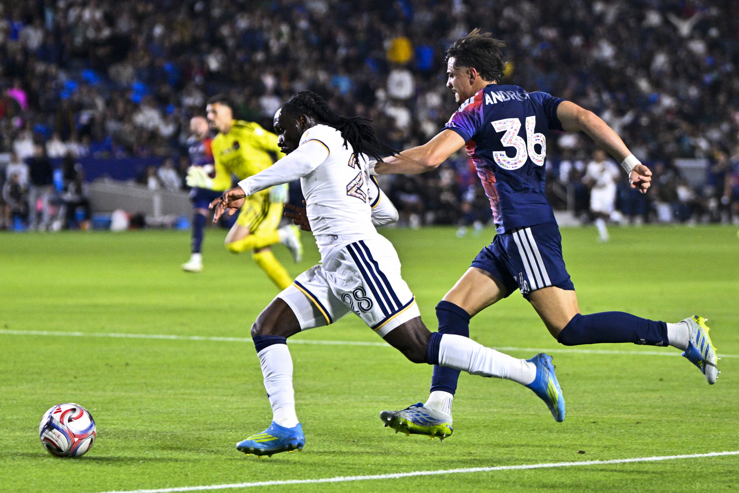 May 23, 2026; Carson, California, USA; LA Galaxy forward Joseph Paintsil (28) moves past Houston Dynamo FC defender Felipe Andrade (36) during the second half at Dignity Health Sports Park. Mandatory Credit: Kelvin Kuo-Imagn Images