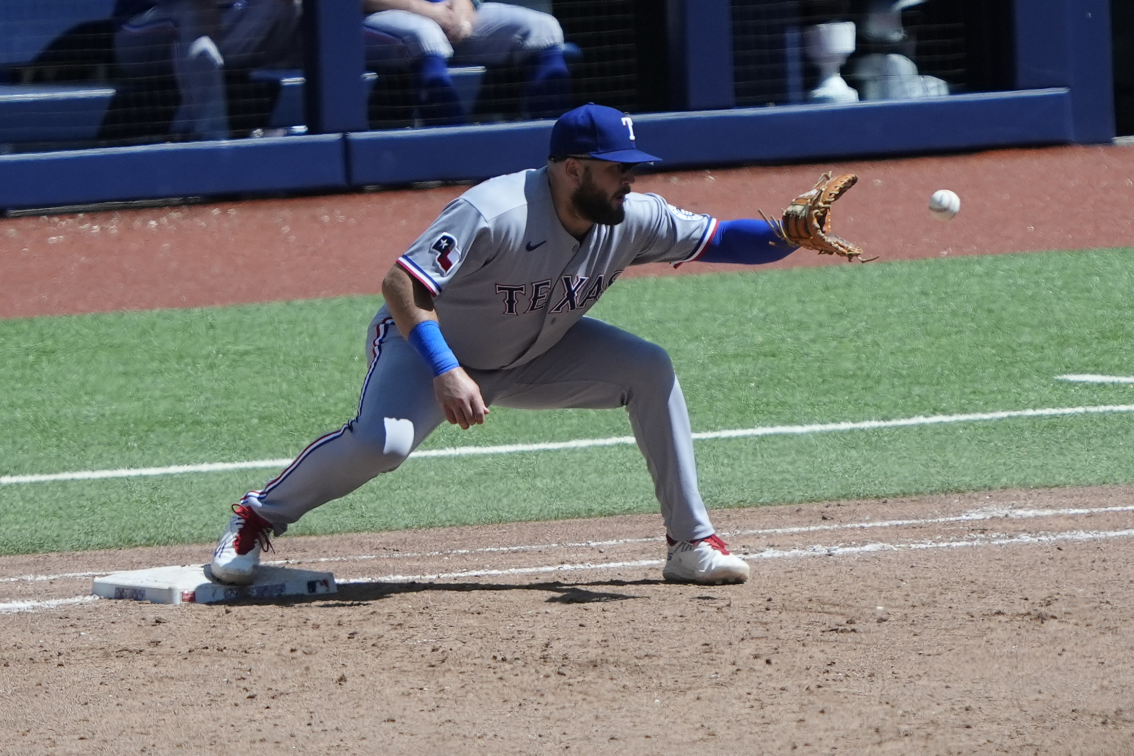 Jun 28, 2026; Toronto, Ontario, CAN; Texas Rangers first baseman Jake Burger (21) gets Toronto Blue Jays third baseman Kazuma Okamoto (not pictured) out at first base during the sixth inning at Rogers Centre. Mandatory Credit: John E. Sokolowski-Imagn Images