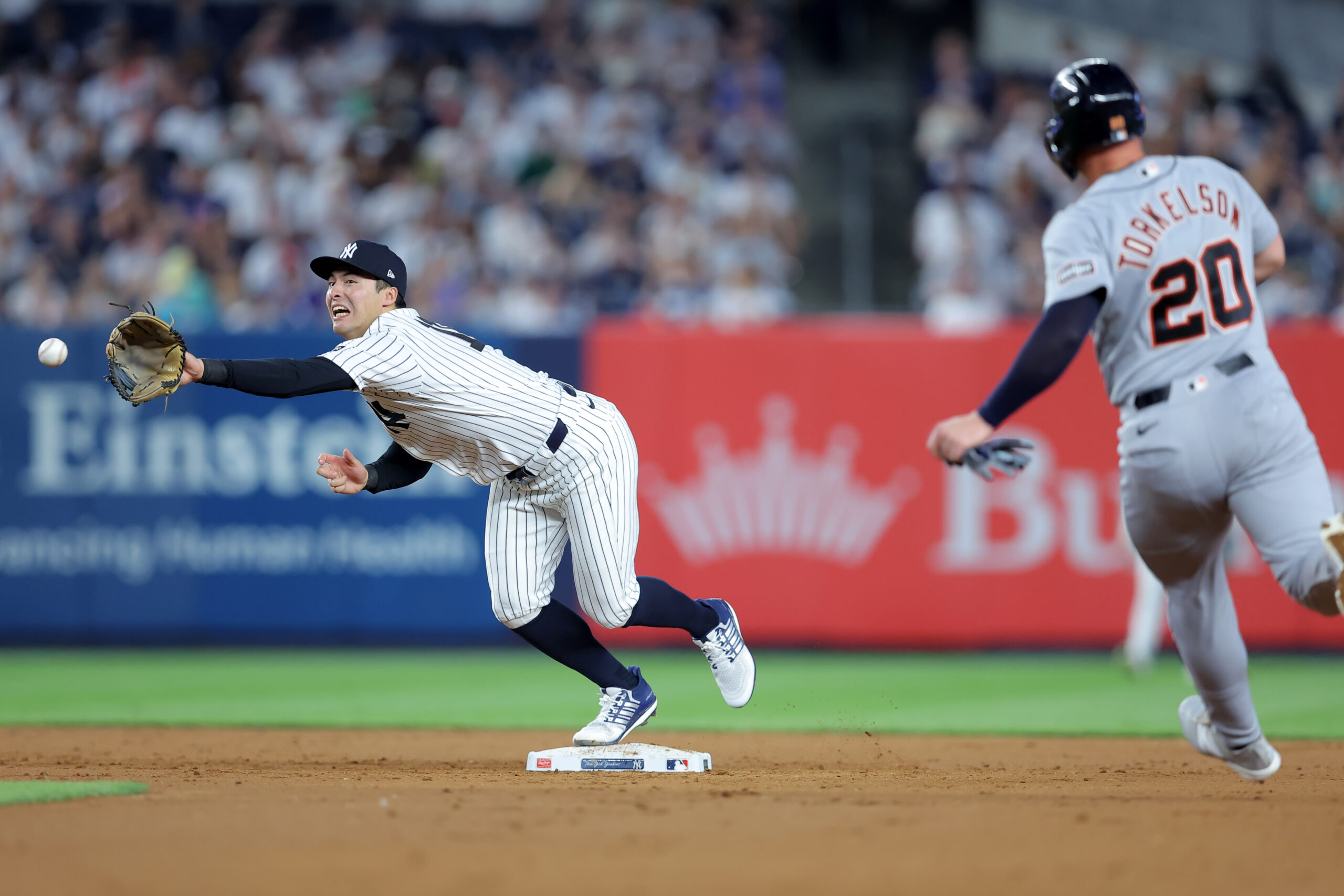 Jun 30, 2026; Bronx, New York, USA; New York Yankees shortstop Anthony Volpe (11) can't catch a throw from second baseman Jose Caballero (not pictured) on a ground ball by Detroit Tigers shortstop Zach McKinstry (not pictured) allowing Tigers first baseman Spencer Torkelson (20) to advance to third base during the sixth inning at Yankee Stadium. Mandatory Credit: Brad Penner-Imagn Images