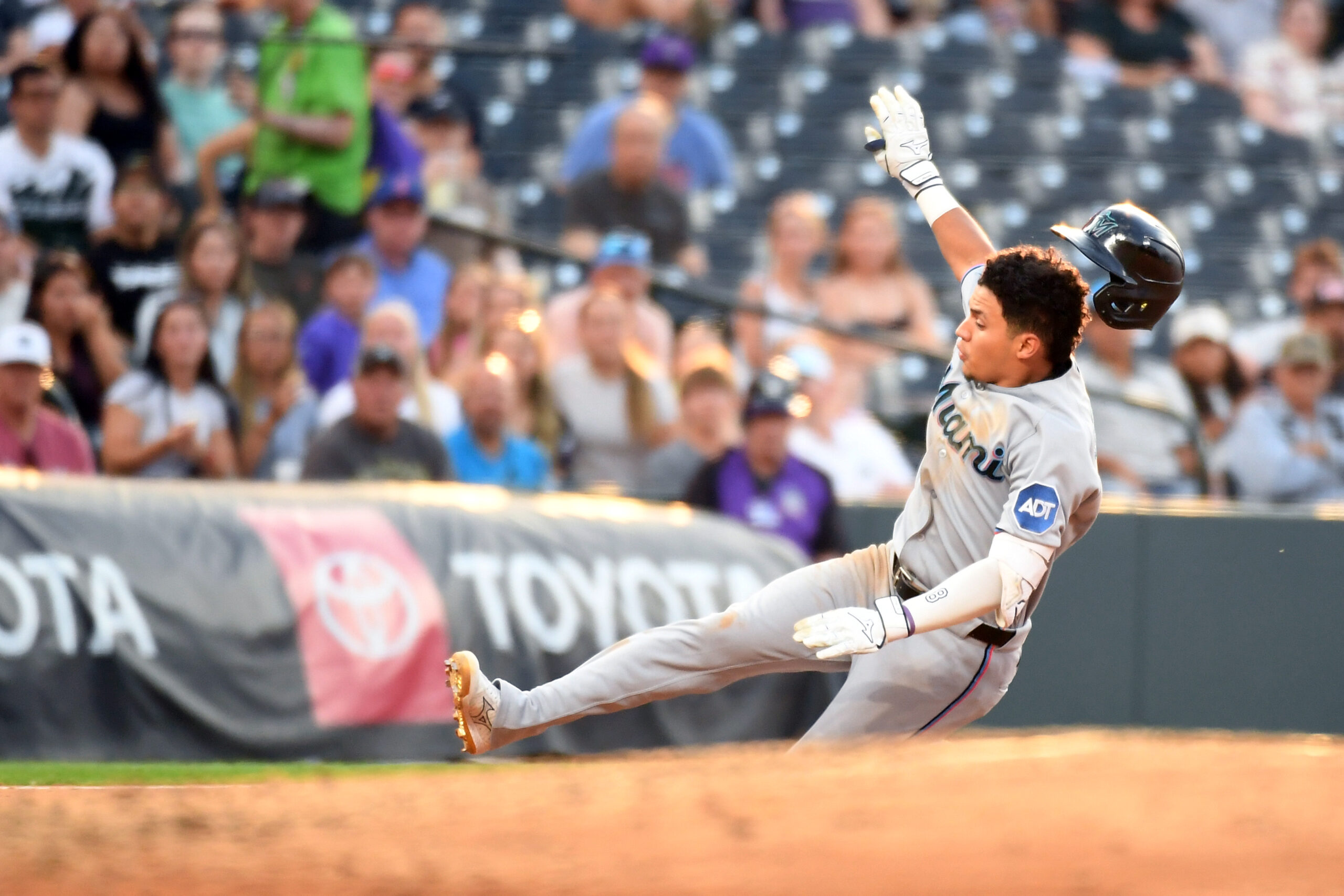 Jul 1, 2026; Denver, Colorado, USA; Miami Marlins infielder Javier Sanoja (8) slides safely into third base after an RBI triple in the fourth inning against the Miami Marlins at Coors Field. Mandatory Credit: Christopher Hanewinckel-Imagn Images